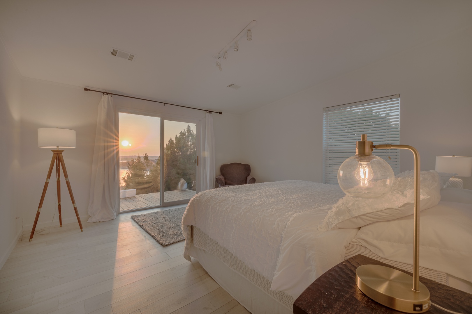 The second primary bedroom with a king-size bed also overlooks the lake with amazing views