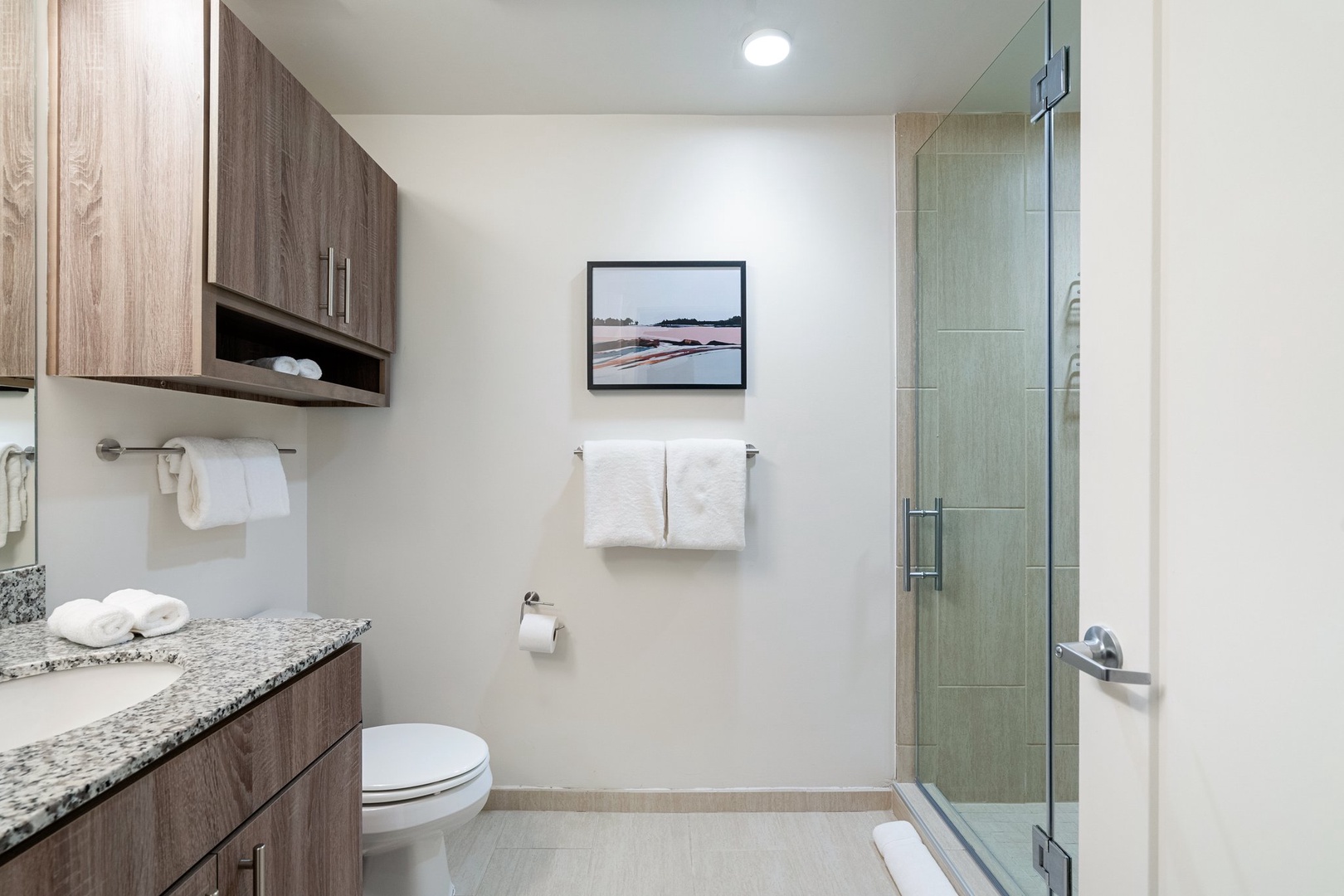 Freshen up in a spacious bathroom with ample storage and a walk-in shower, MALIN+GOETZ toiletries, plush bath towels, pool towels, a hairdryer, and hair straightener / flat iron.