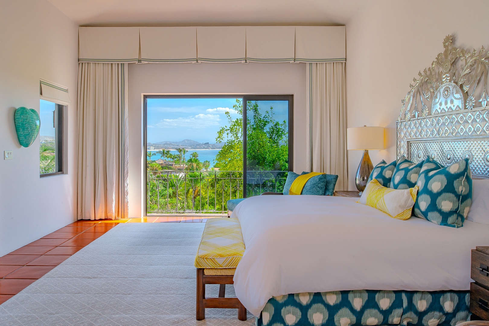 Wake up to stunning coastal views framed by your private balcony, where turquoise waters meet lush tropical greenery and distant mountain horizons create your perfect escape.