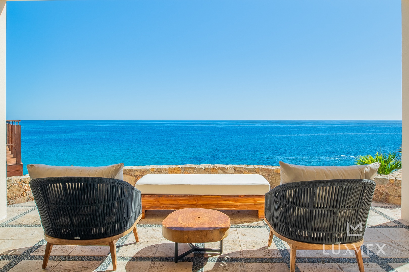 Step onto your private terrace where plush seating awaits, perfectly positioned for endless ocean gazing and sunset moments.