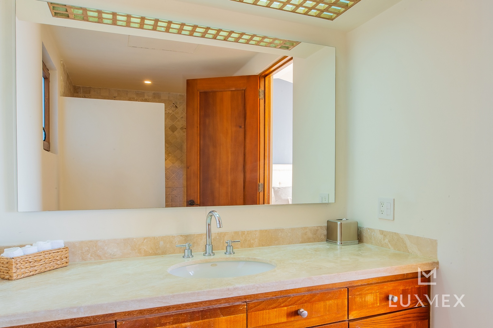 Pamper yourself at this elegant vanity with marble countertops and rich wood cabinetry, where morning routines feel luxurious.