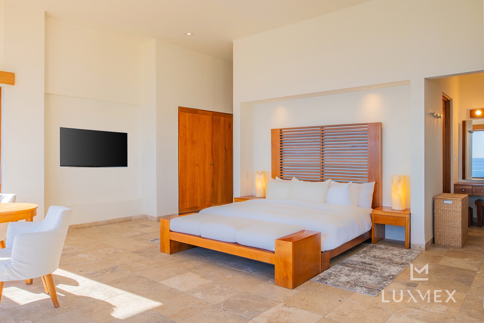 Your master bedroom features elegant wood furnishings and crisp linens, creating a peaceful retreat for restful nights.