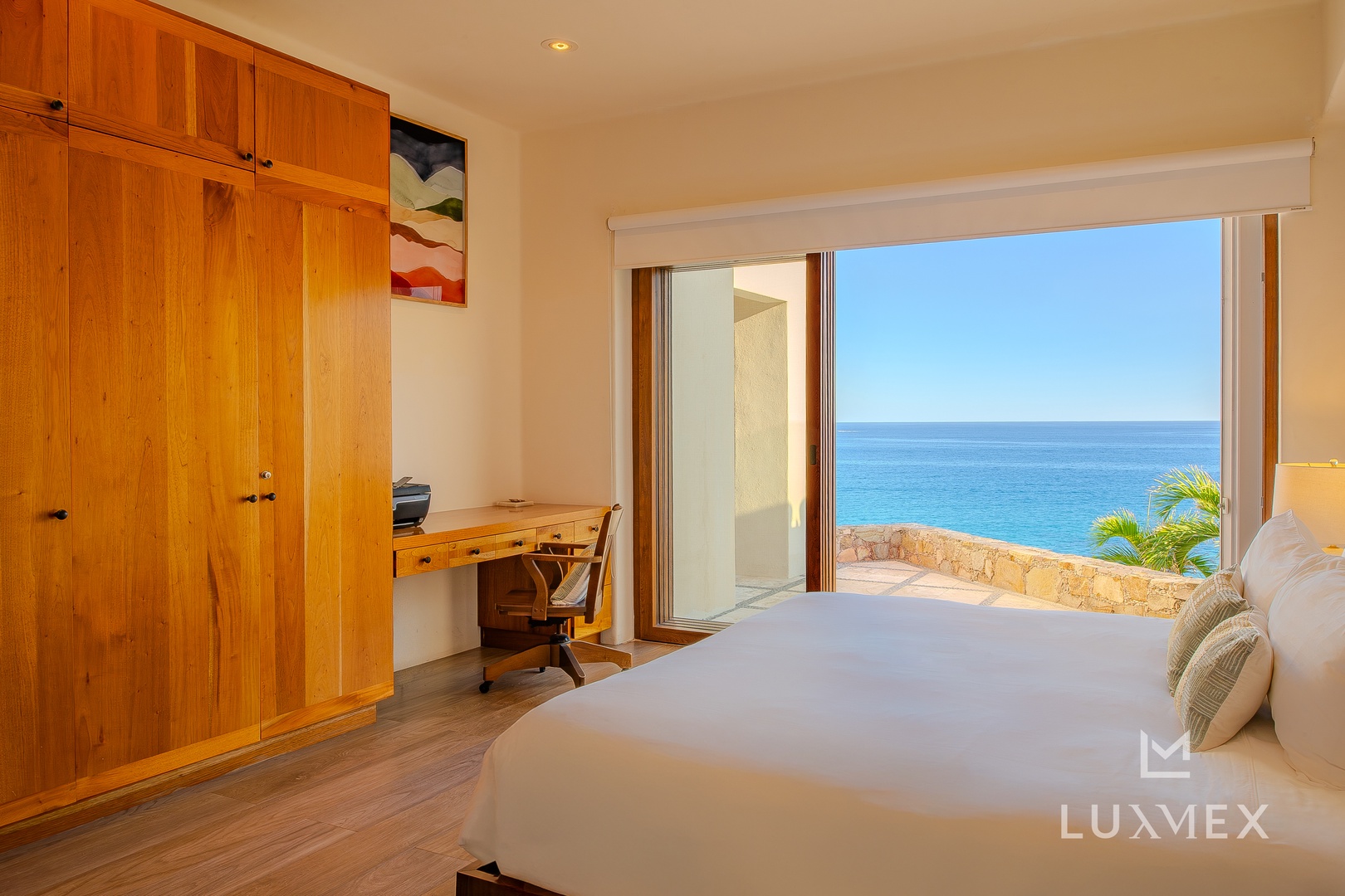 Wake up to breathtaking ocean views from your comfortable bed, where azure waters stretch endlessly beyond your private terrace.