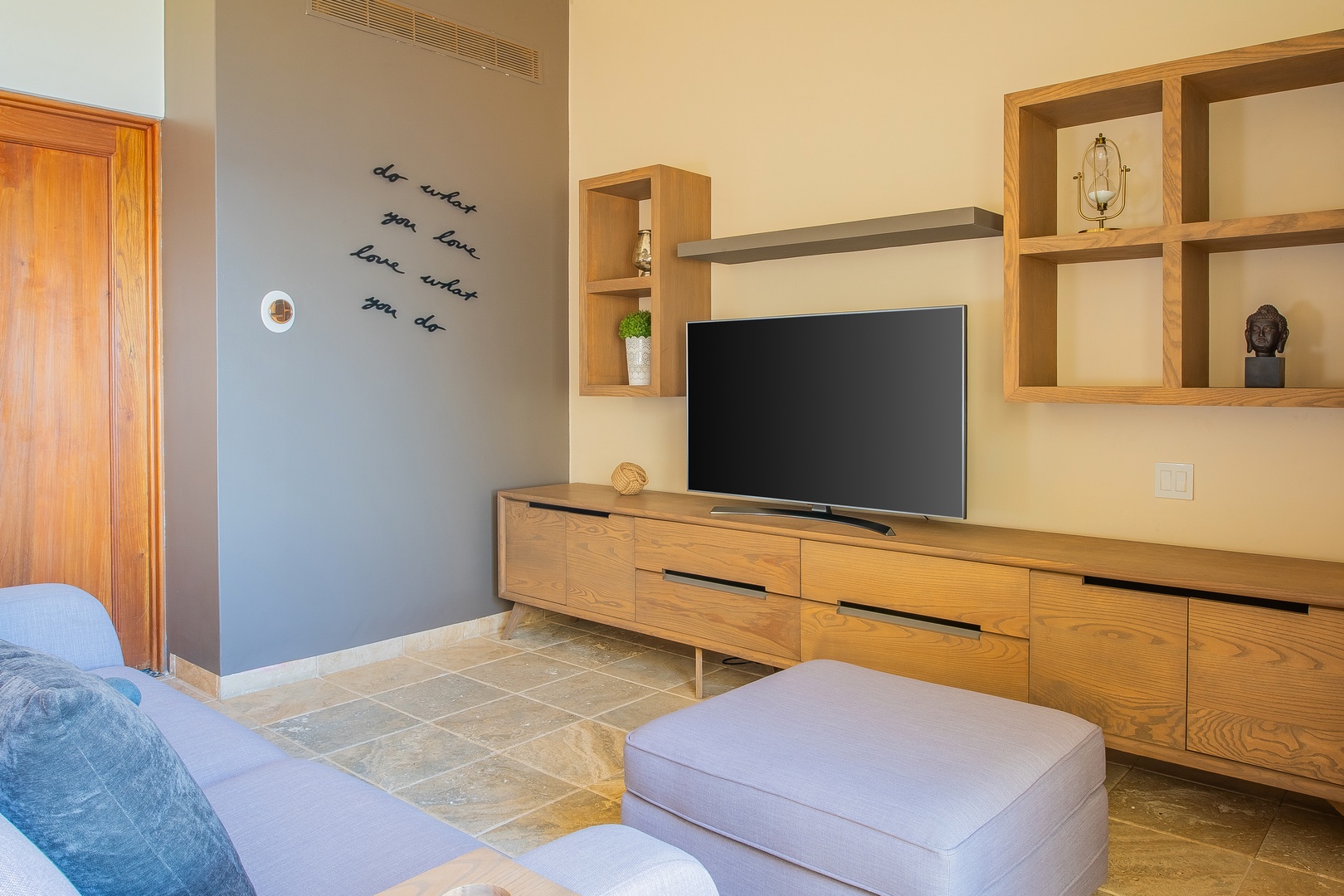 Unwind in your stylish living room with modern oak furnishings, a flat-screen TV, and thoughtful touches like wall art and curated décor.