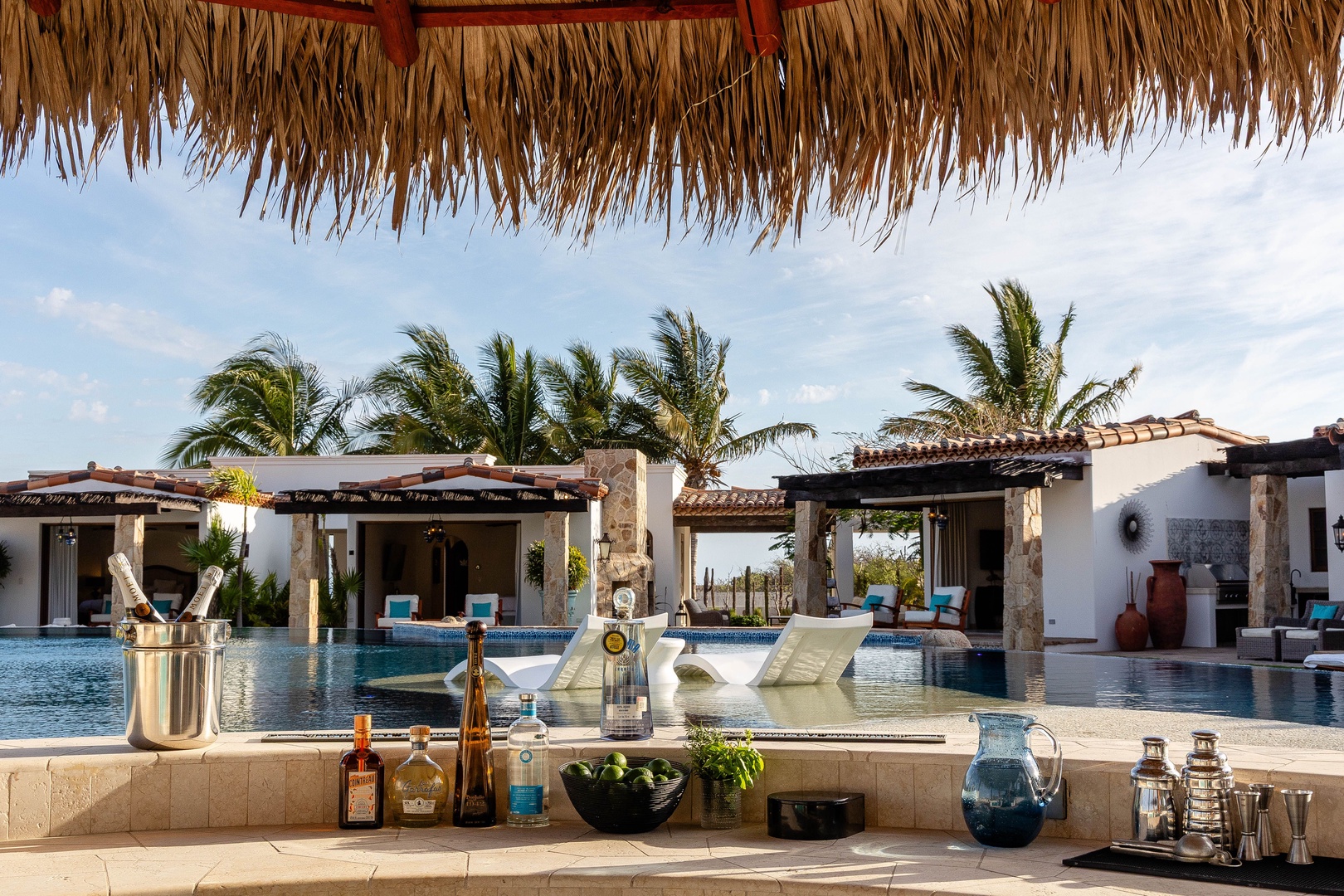 Sip your favorite drink poolside beneath swaying palms—your private oasis awaits under sunny skies and tropical breezes.