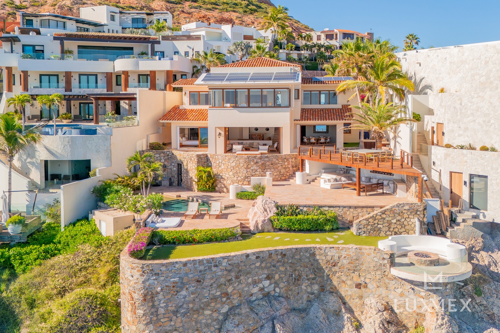 Spectacular hillside villa with expansive terraces, multiple pools, and stunning architectural design nestled in tropical surroundings.