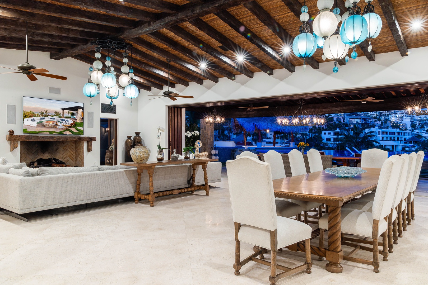 Gather around the grand dining table under stunning turquoise pendant lights, with your living area flowing seamlessly to the terrace and ocean views beyond.