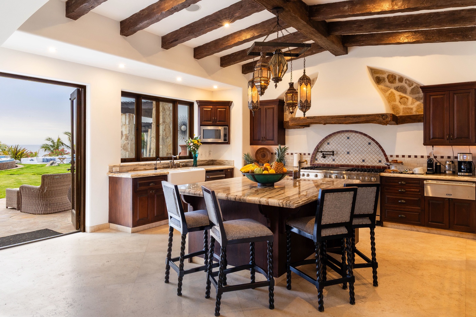 Step into your dream kitchen where rustic elegance meets modern comfort. Handcrafted beams and ambient lighting set the stage for memorable meals, while tropical breezes drift in from your private ocean-view patio.
