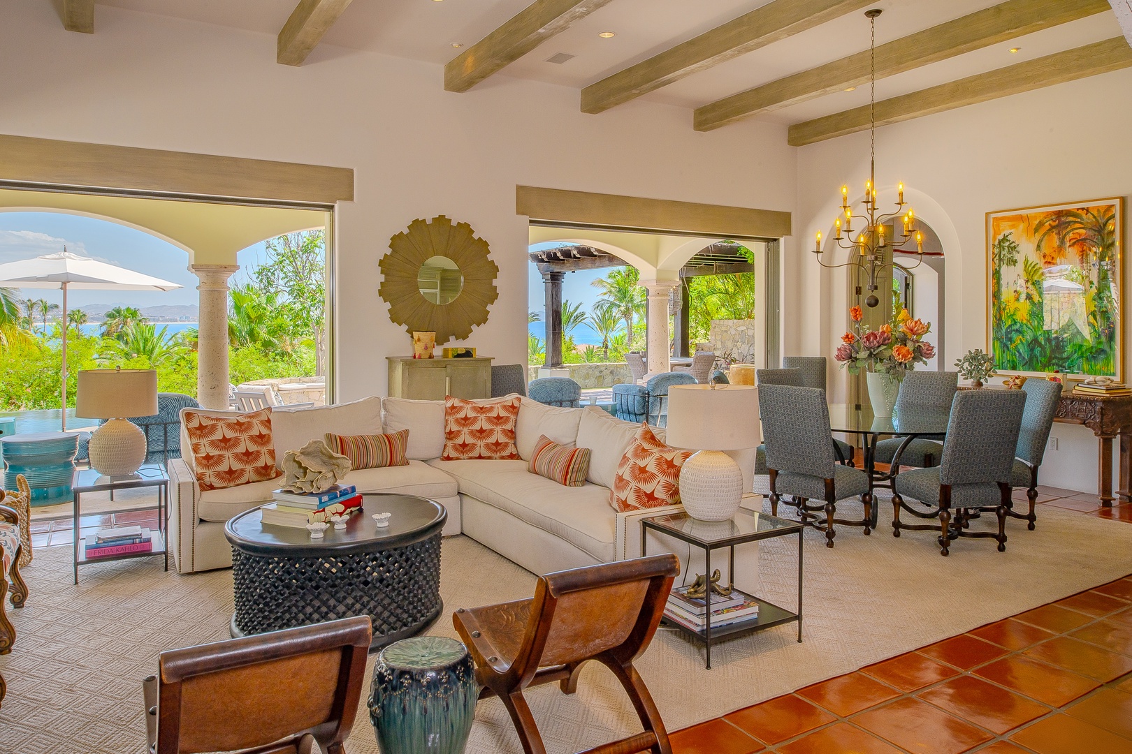 Sink into plush seating surrounded by vibrant decor and arched openings that frame lush tropical views, creating your perfect backdrop for morning coffee or sunset drinks.