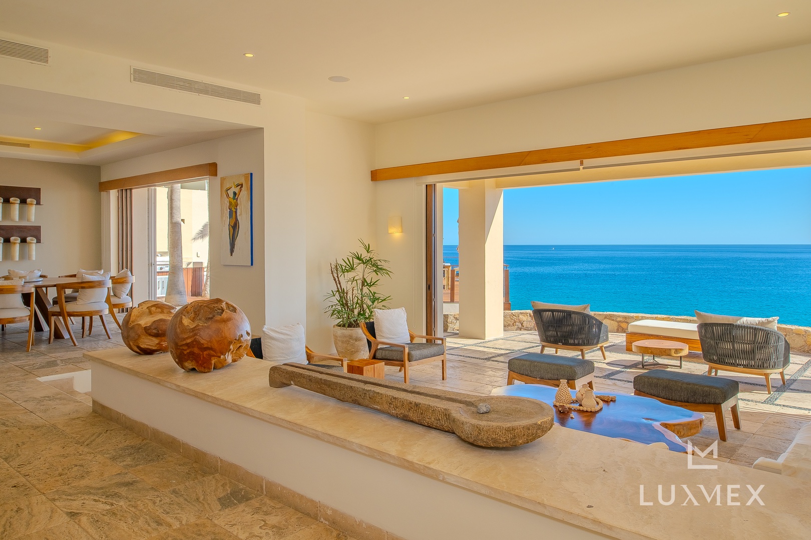 Your stunning oceanfront living room opens to panoramic sea views, where modern luxury meets coastal serenity in perfect harmony.