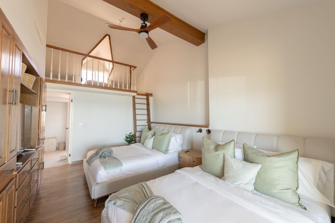 Soaring ceilings and soft linens create a bright, airy sanctuary where you'll drift off easily. The private loft above adds extra charm and space for your group.