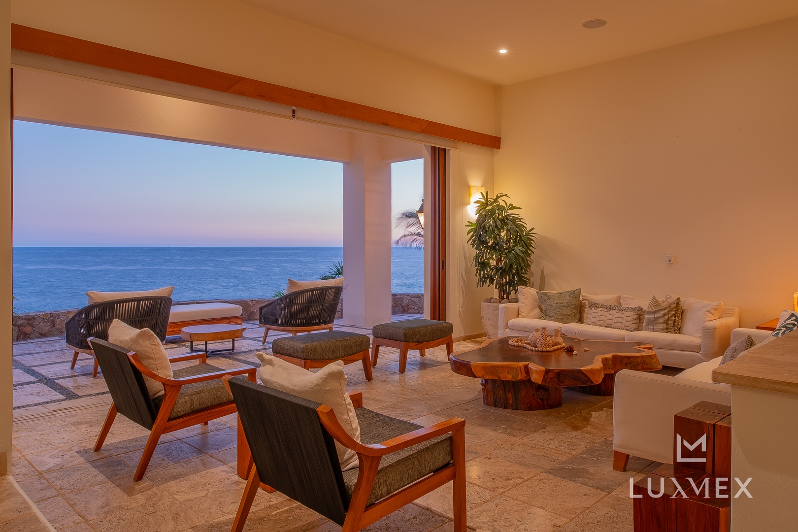 Unwind in your spacious living area where floor-to-ceiling windows frame breathtaking ocean views, creating the perfect backdrop for relaxation.