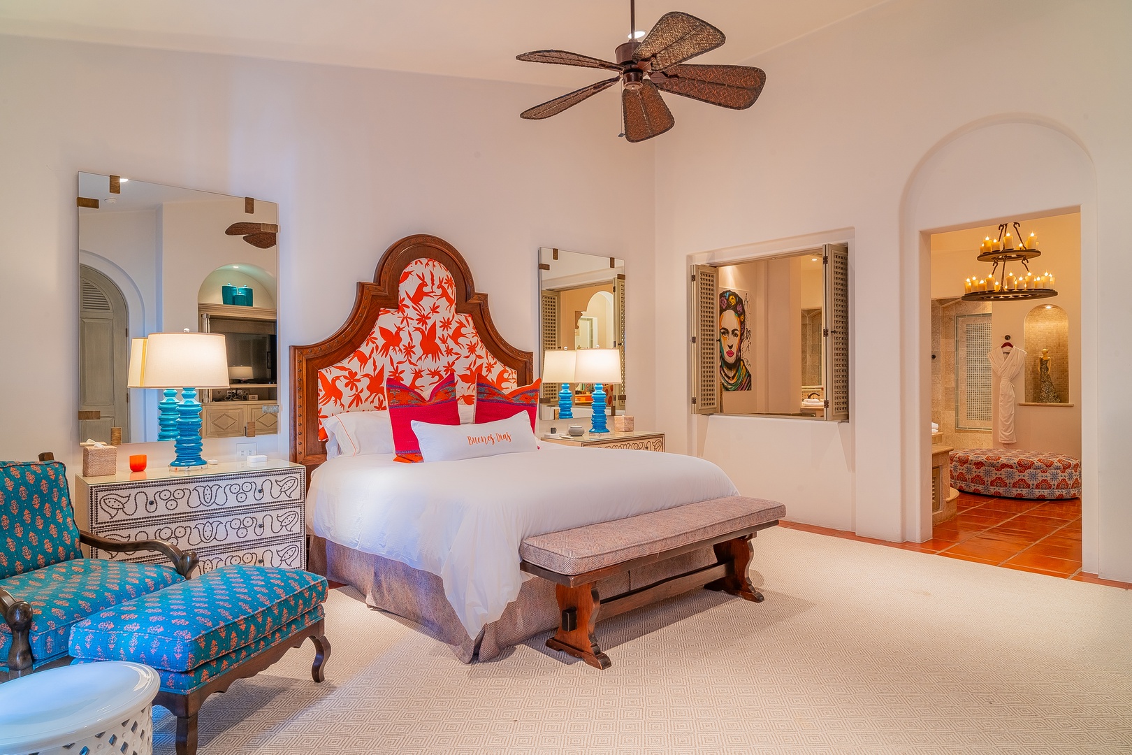 Your spacious bedroom welcomes you with vibrant decor, a luxurious king bed, and charming archway views into cozy adjacent spaces—perfect for unwinding in style.
