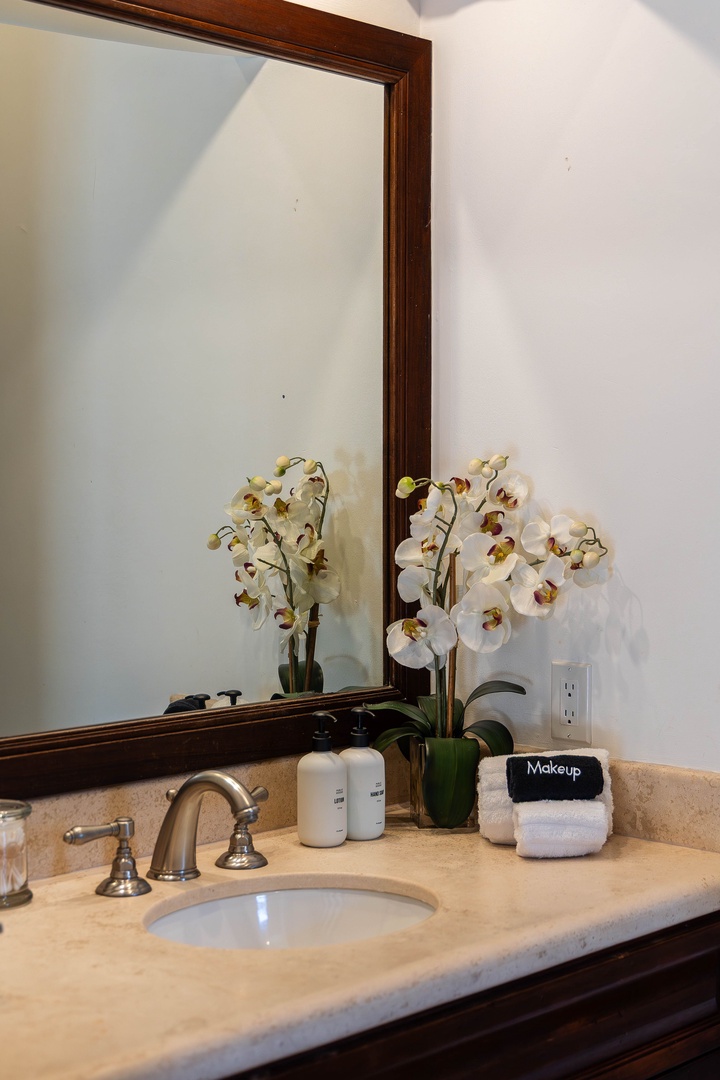 Freshen up at your private sink, where warm lighting, soft towels, and thoughtful details welcome you home each day.