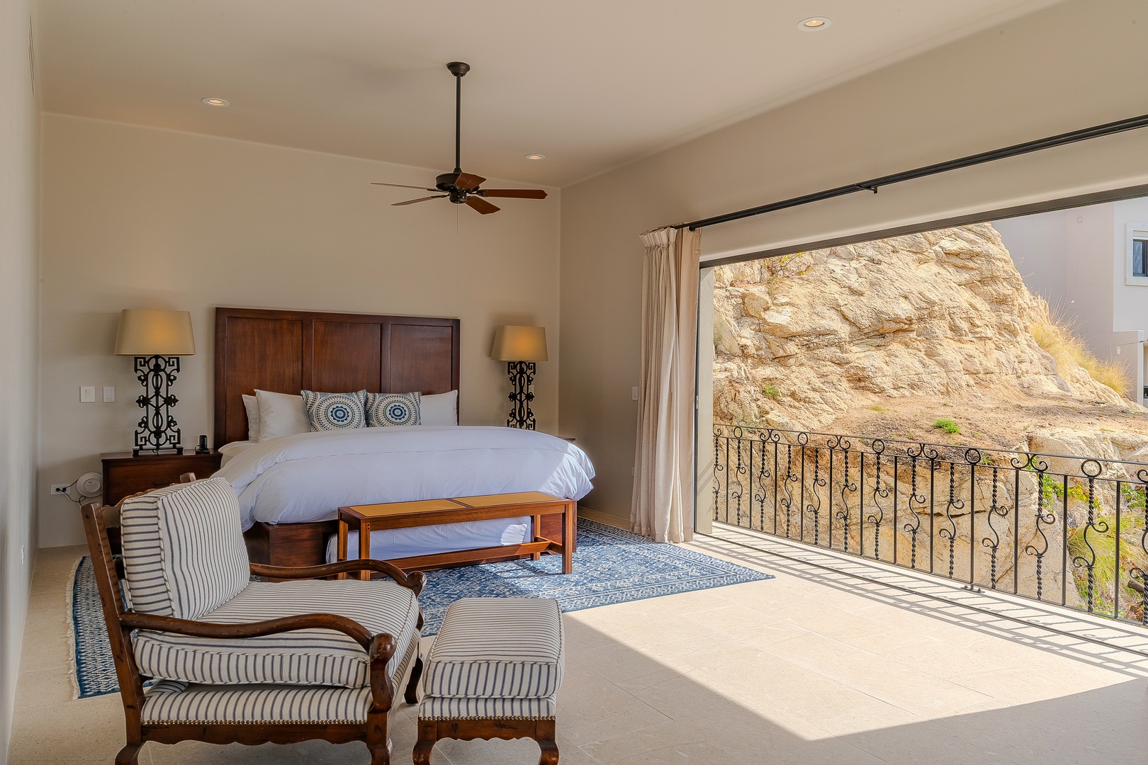Wake up in your spacious bedroom where morning light streams through expansive windows, revealing stunning desert canyon views from your private balcony.