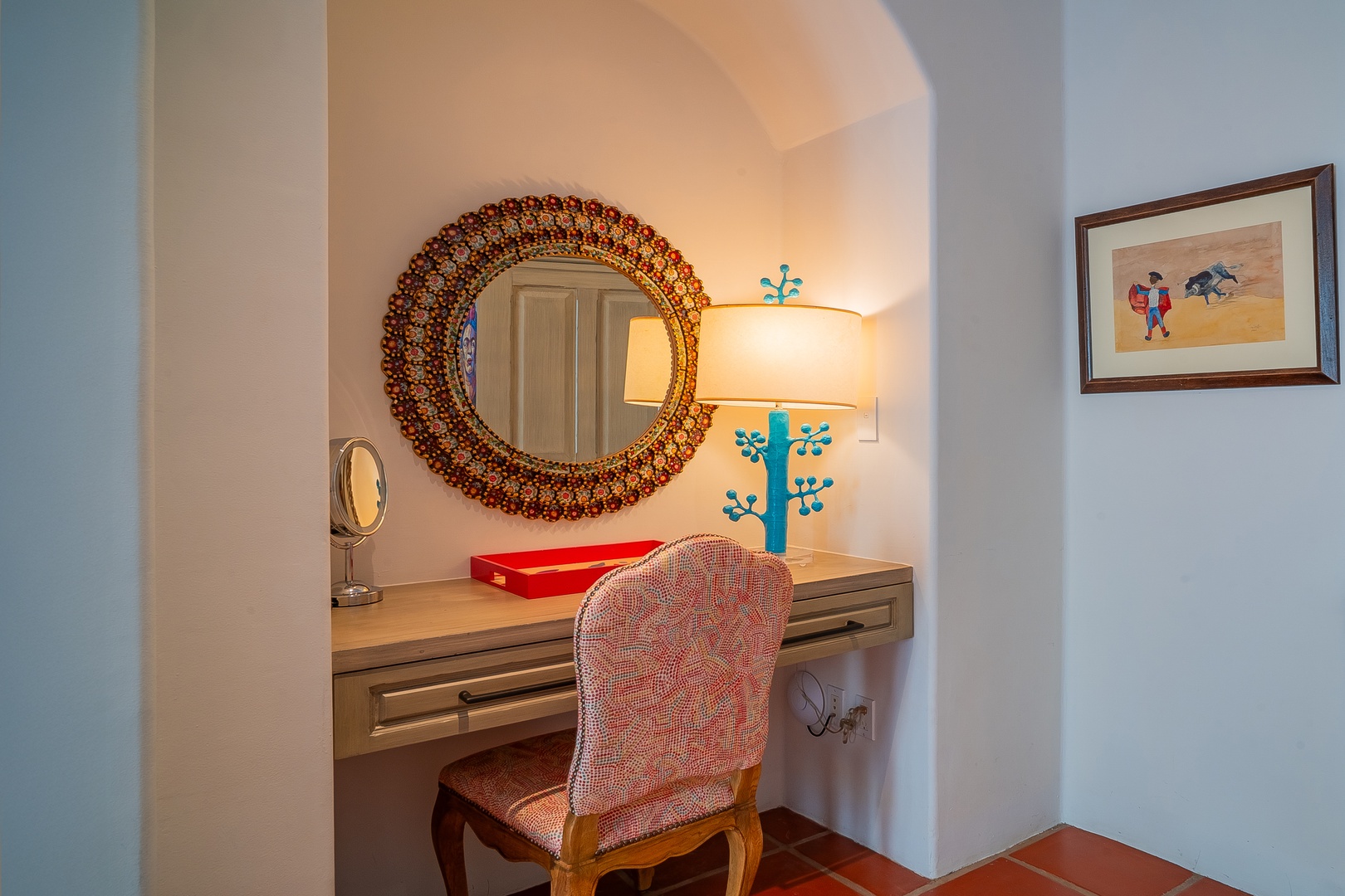 Settle into your private vanity nook, where warm lighting and a handcrafted mosaic mirror create a cozy space to start your mornings with ease.