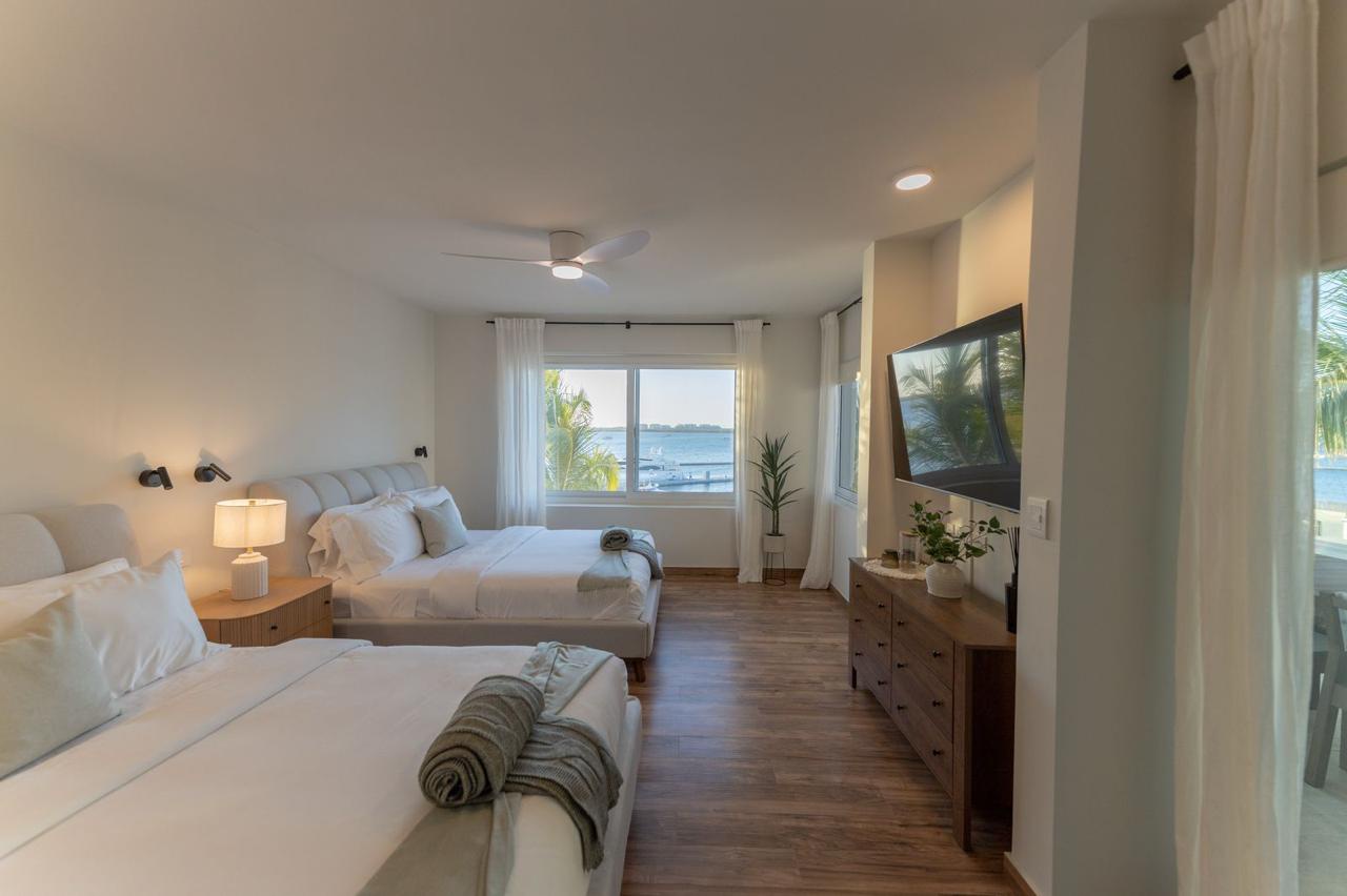 Settle in and breathe easy in your spacious waterfront bedroom with two plush beds, serene ocean views, and gentle coastal breezes to lull you to sleep.