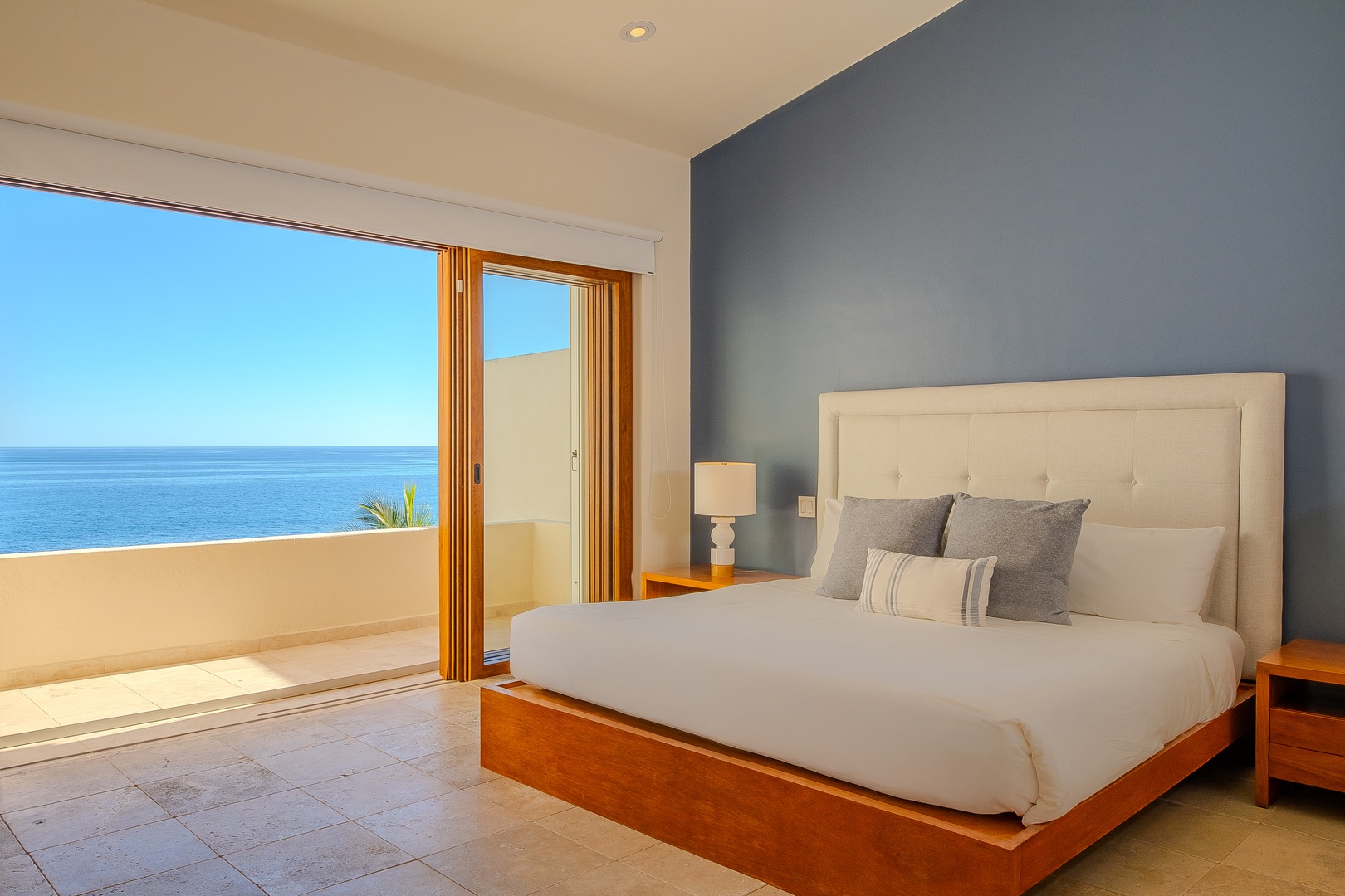 Wake up to stunning ocean views from your elegant bedroom, where a plush king bed and serene coastal palette invite total relaxation and restful nights.