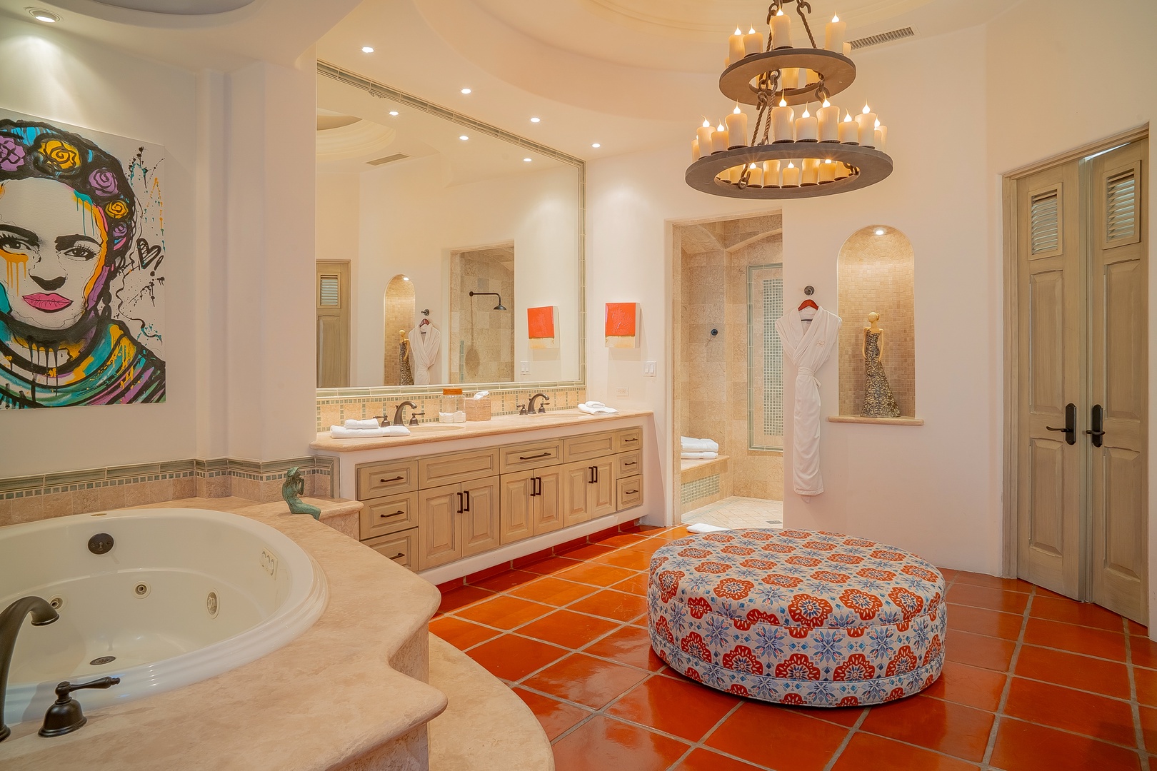 Indulge in a spa-like retreat with vibrant artwork, a luxurious soaking tub, and twin vanities framed by warm lighting. Your private sanctuary awaits with thoughtful details and refined finishes throughout.