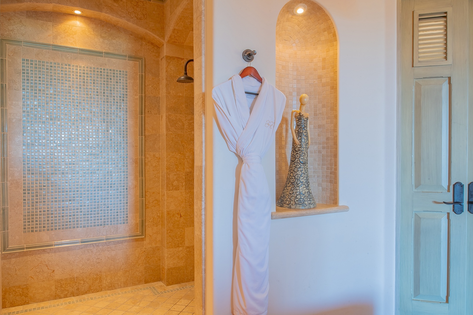 Step into your luxurious spa-inspired bathroom, where a plush white robe awaits and your private tiled shower promises pure relaxation after a long day exploring.