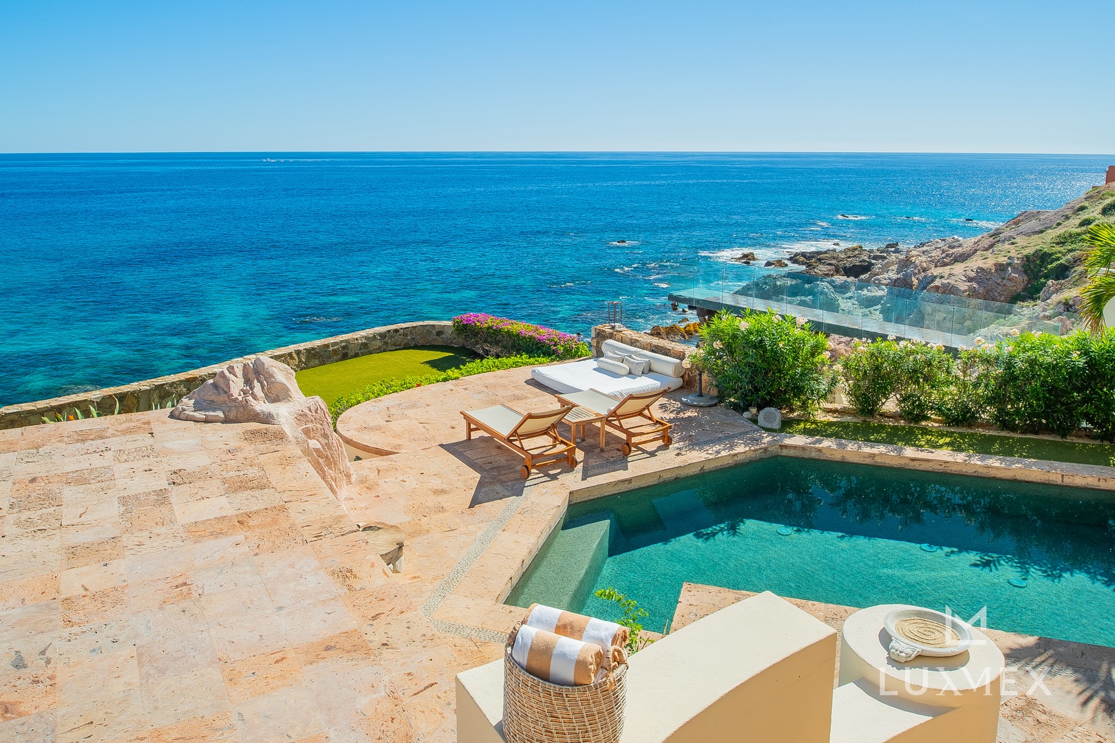 Your private oceanfront terrace features a stunning pool overlooking endless turquoise waters, perfect for morning swims and sunset lounging.