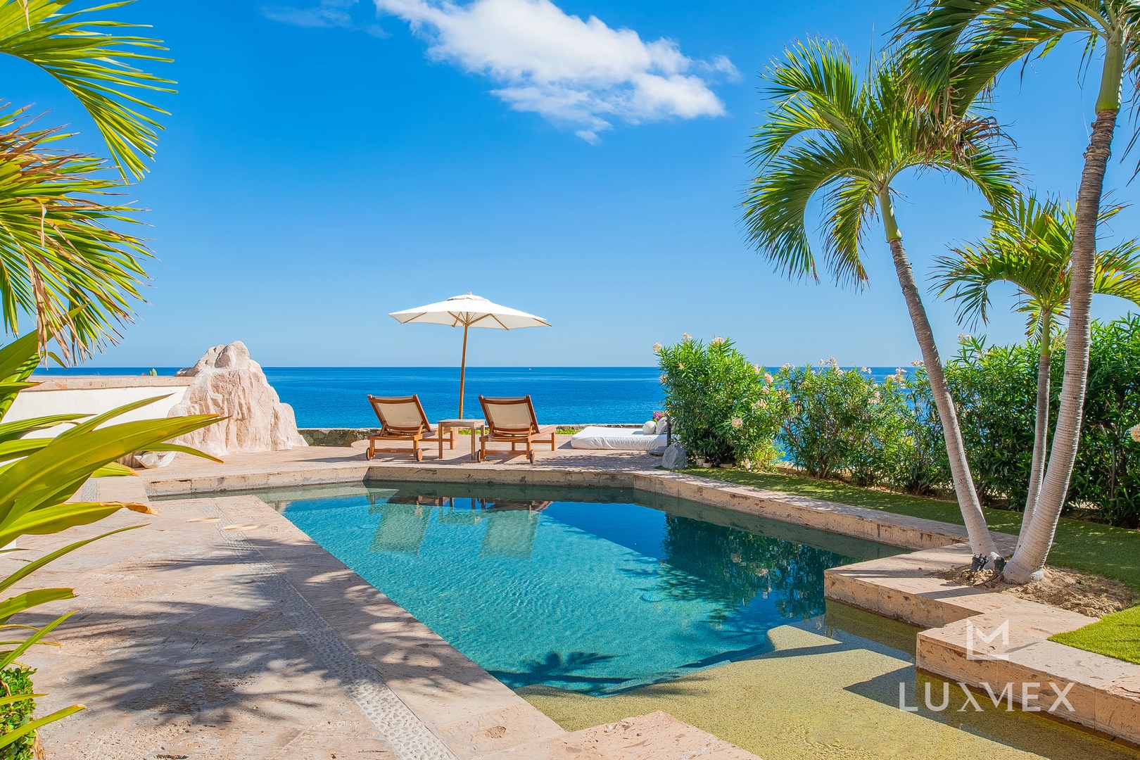 Private pool paradise with ocean views and swaying palms creates the perfect tropical escape.