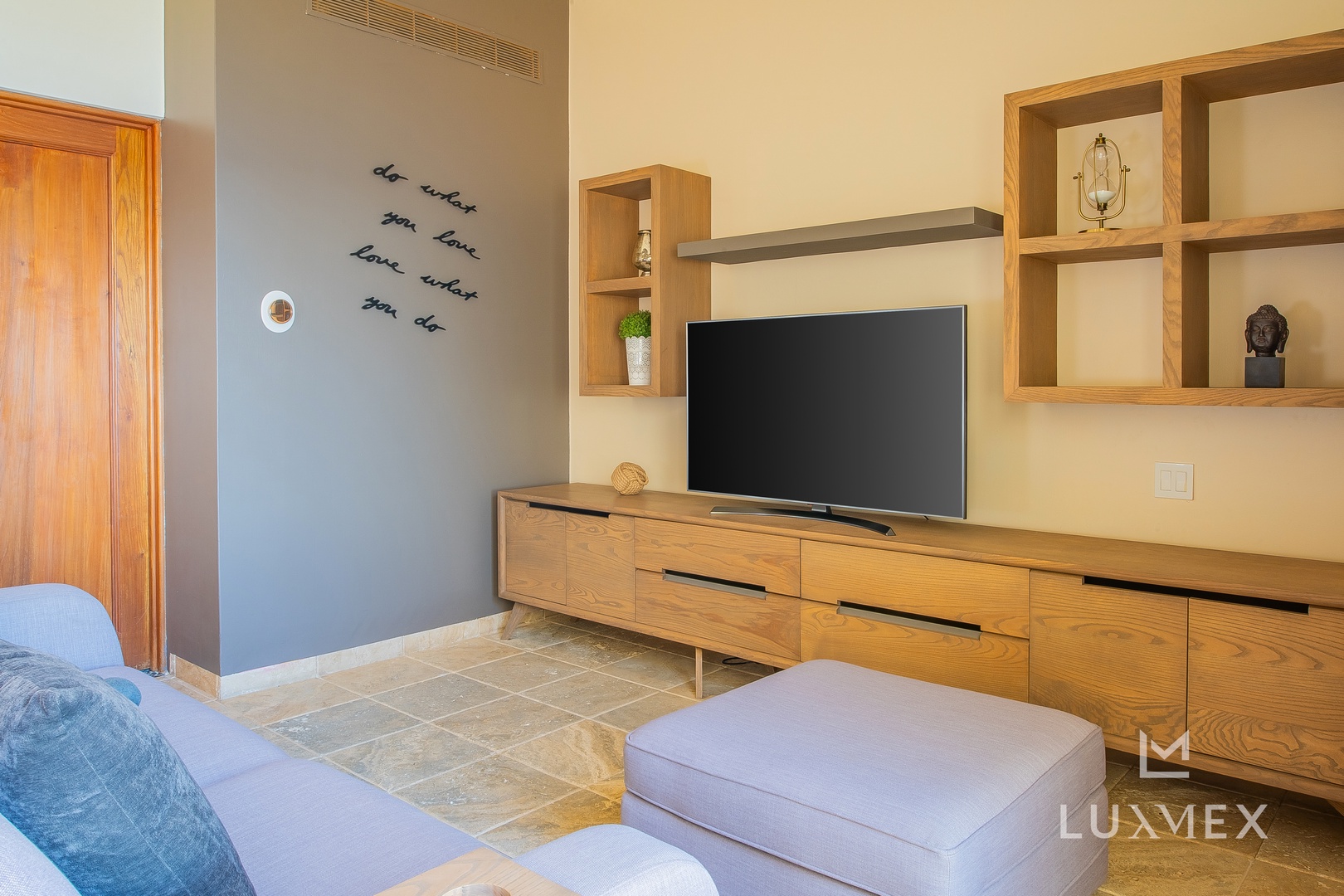 Relax in your thoughtfully designed living space with warm wood furnishings, modern amenities, and inspiring wall art.