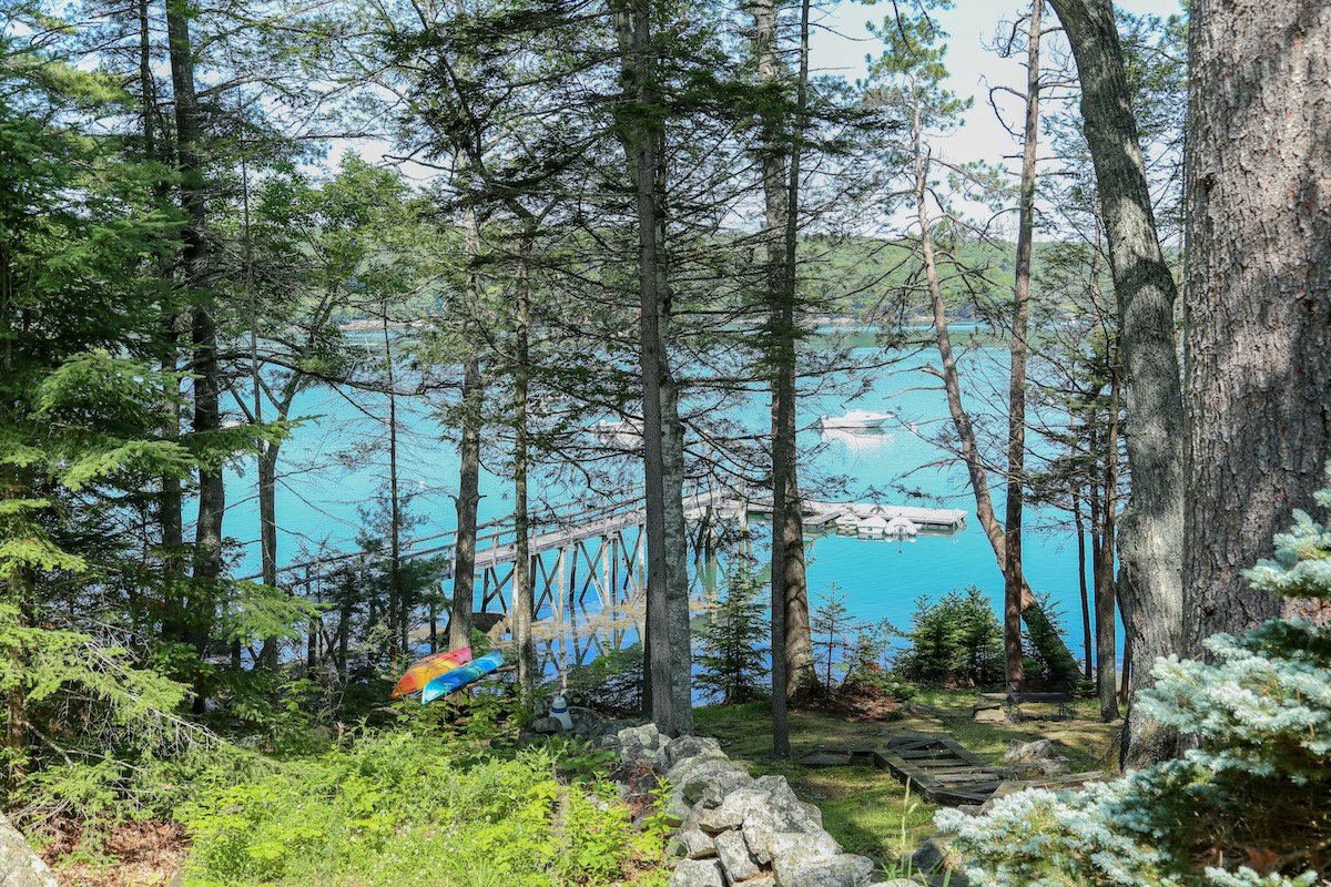 Property nestled in natural woodland with a shared dock on stunning Damariscotta River—a serene waterfront setting perfect for peaceful stays.