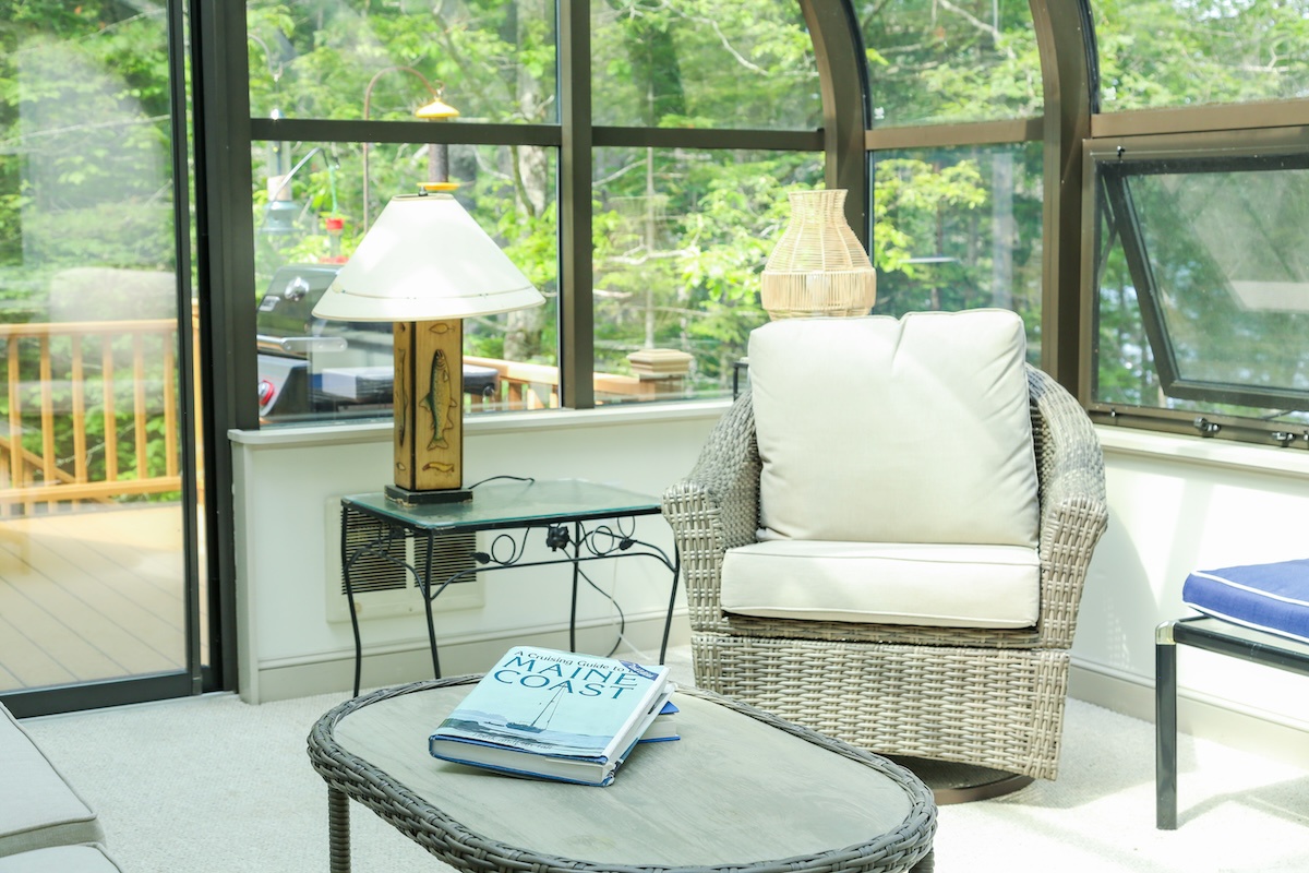 Your private sunroom invites you to curl up with a favorite book, surrounded by lush greenery and natural light streaming through floor-to-ceiling windows.