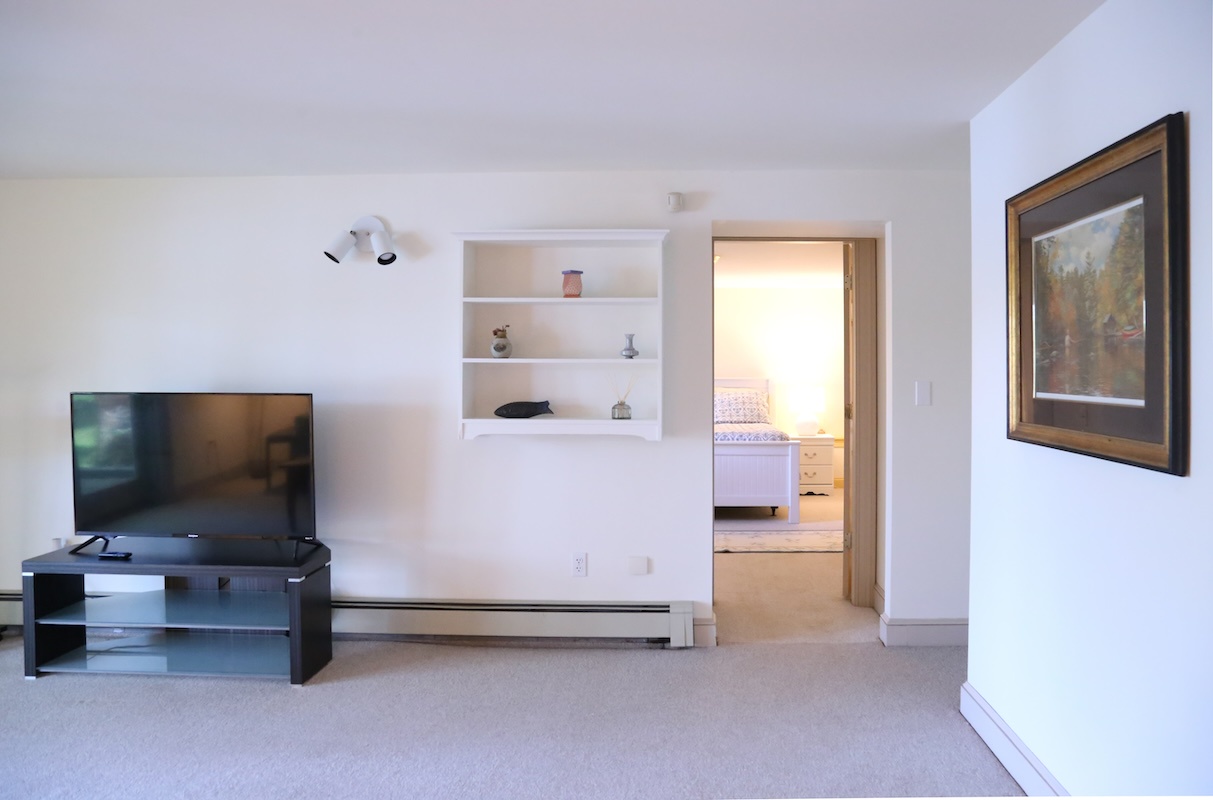 Your living space opens to a cozy bedroom, offering simple comfort and a warm, uncluttered atmosphere perfect for relaxing after a day of exploring.