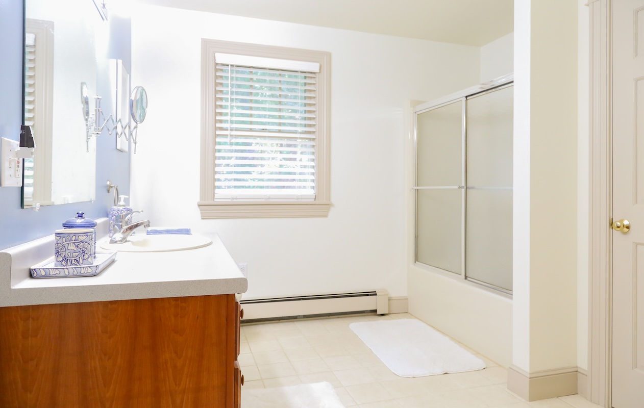 Step into your private bathroom with a sleek walk-in shower and plenty of natural light. The bright, clean space offers everything you need to refresh after a day of adventure.