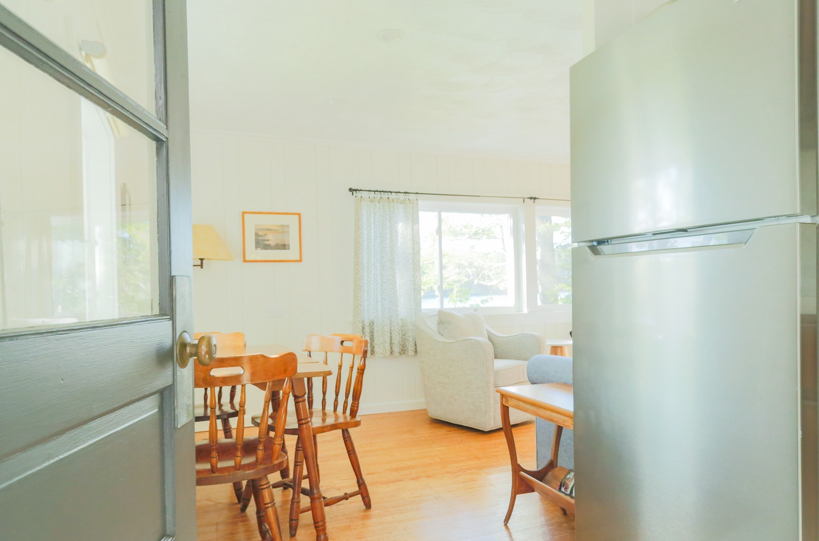 Bright and airy, your dining space flows into a cozy living area where you can unwind. Soft natural light pours through the windows, inviting you to settle in and feel right at home.