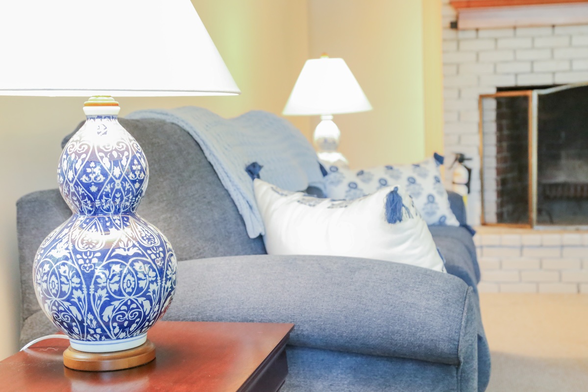 Sink into a cozy armchair perfect for your morning coffee or evening book. The soft blue upholstery and decorative pillows invite you to unwind in style.