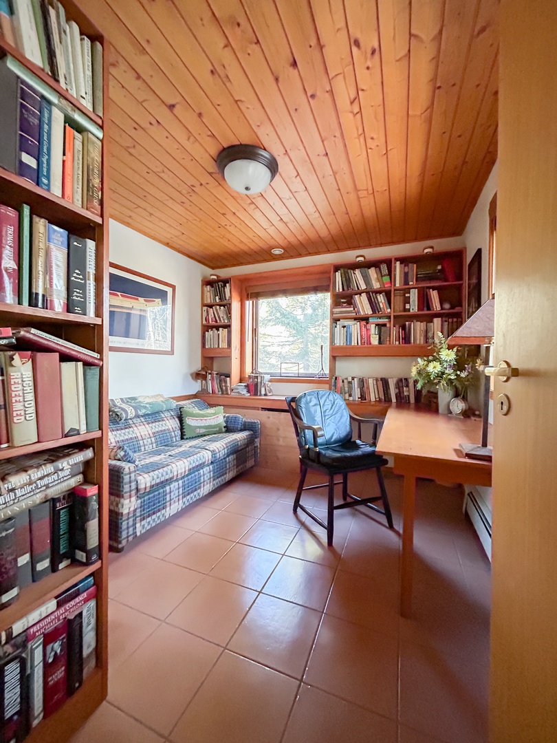 Settle into your private library sanctuary, where floor-to-ceiling bookshelves and a cozy reading nook create the perfect escape for quiet moments.
