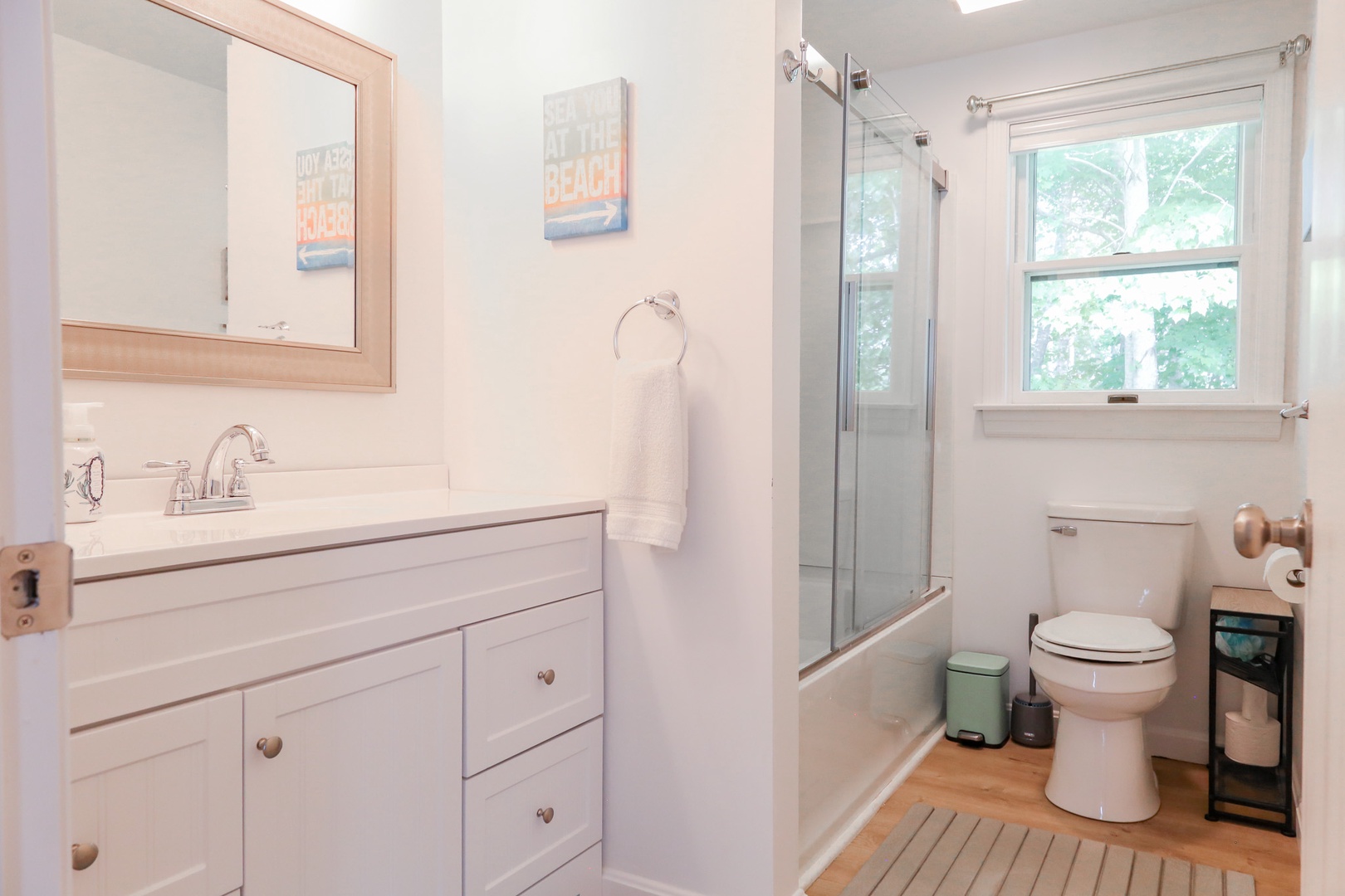 Refresh in your bright, airy bathroom with a spacious shower and tub and natural light streaming through the window. Everything's here for your comfort.