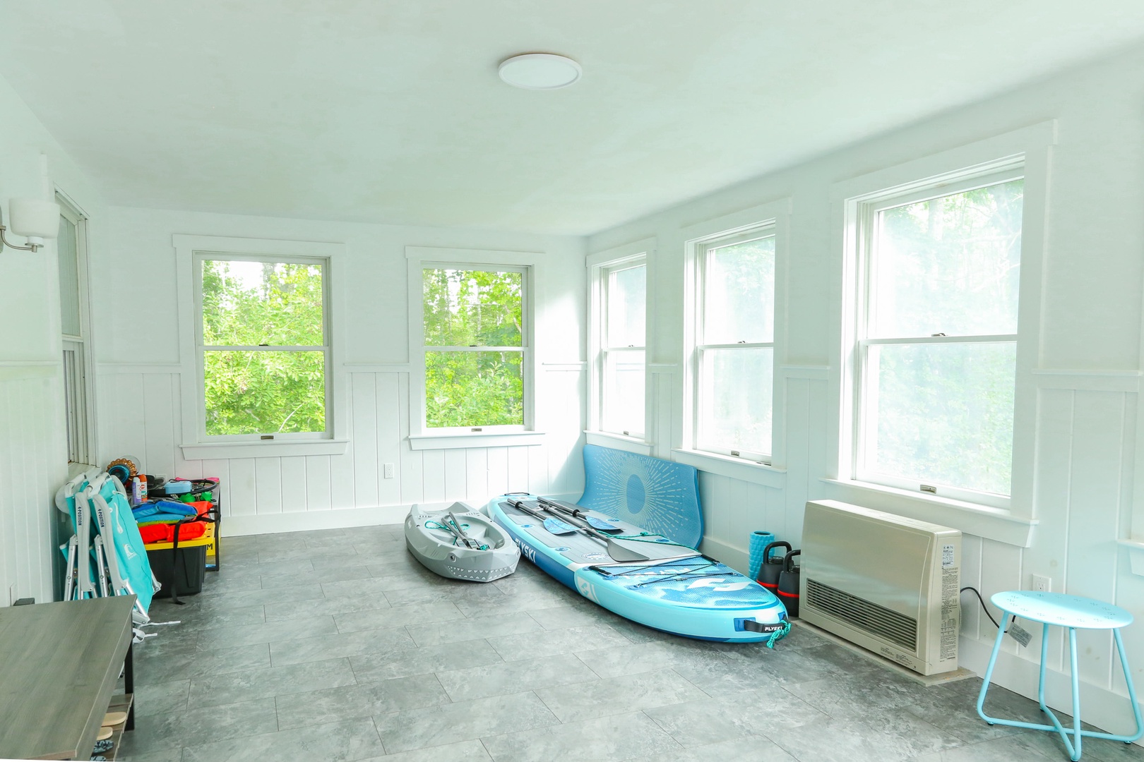 Your adventure starts here. Store your kayak and paddleboard in this bright, spacious sunroom flooded with natural light and ready for your next waterside escape.