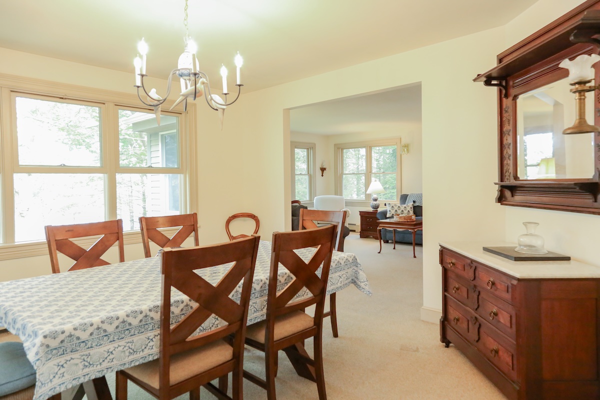 A bright, welcoming dining space where you'll enjoy meals together around the table. Natural light streams through tall windows while elegant details create a classic, comfortable atmosphere for your stay.