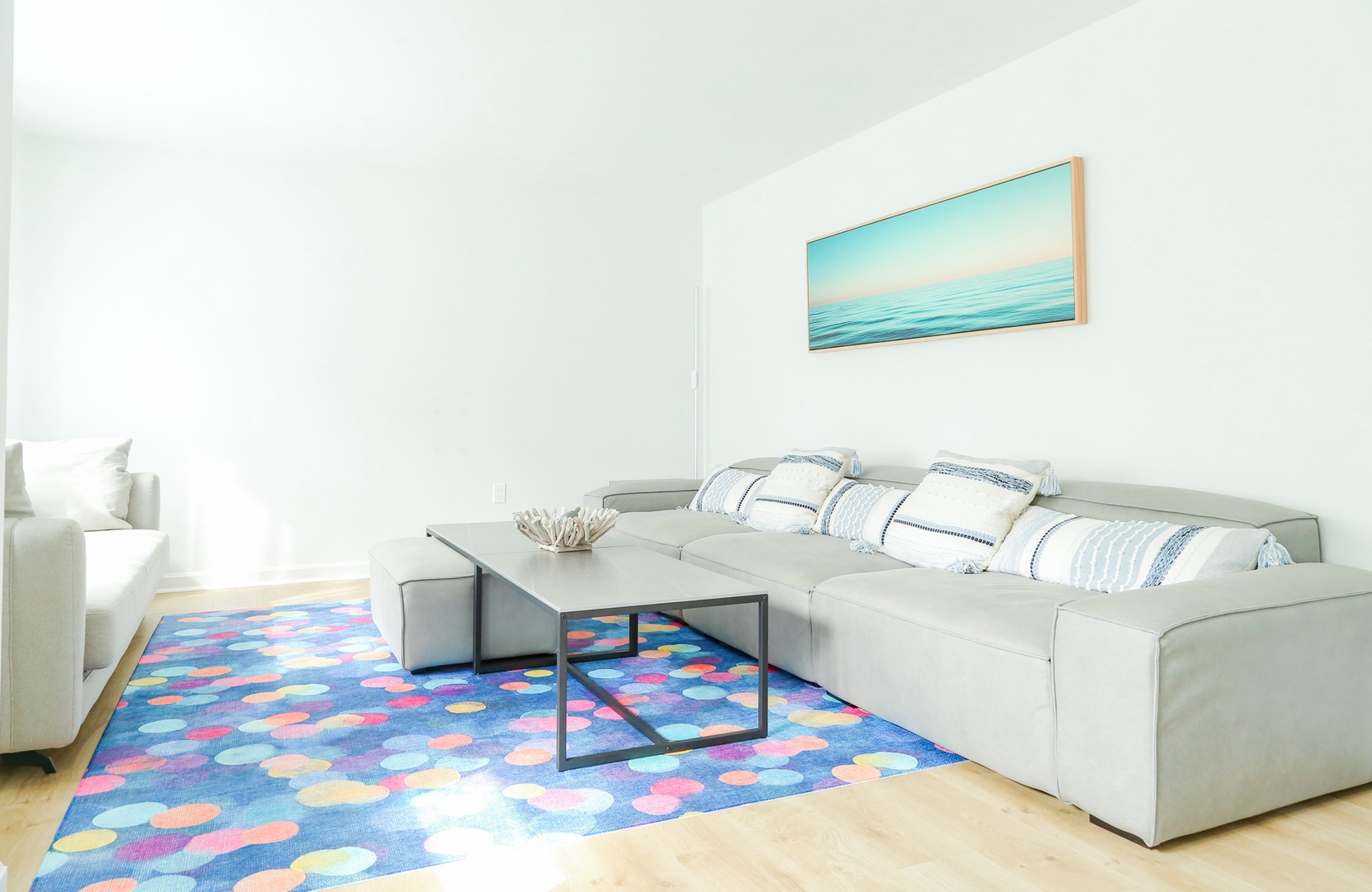 Settle into your bright, airy living space with plush seating and coastal touches that invite you to unwind in comfort.