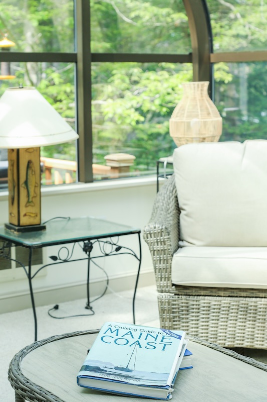 Sink into plush seating as natural light pours through curved windows, revealing lush garden views. Your perfect spot to unwind with a book and soak in the peaceful surroundings.