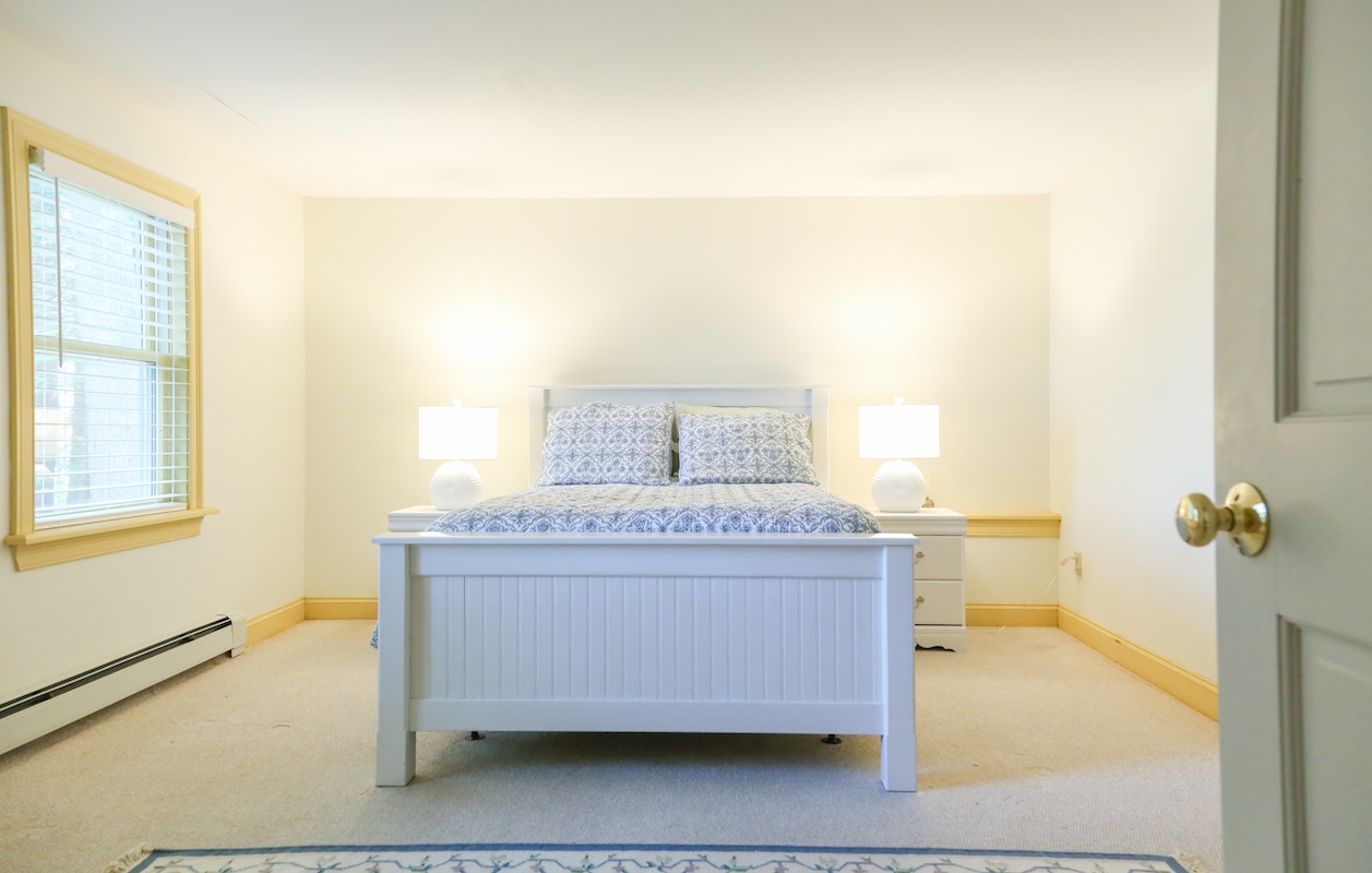 Step into your bright, airy bedroom where a plush bed awaits you after a day of adventure. Soft natural light fills the space, inviting you to unwind in calm, coastal-inspired comfort.