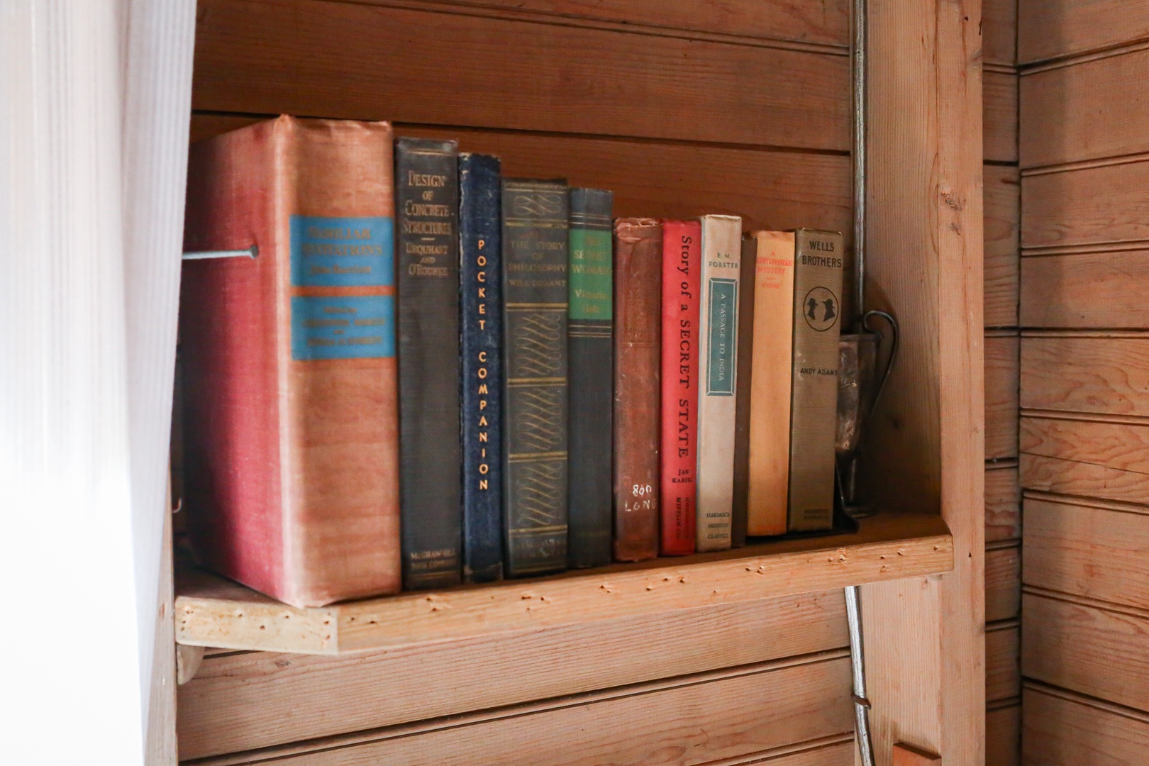 Cozy up with a good book from your personal collection of classic novels and stories on these charming wooden shelves.