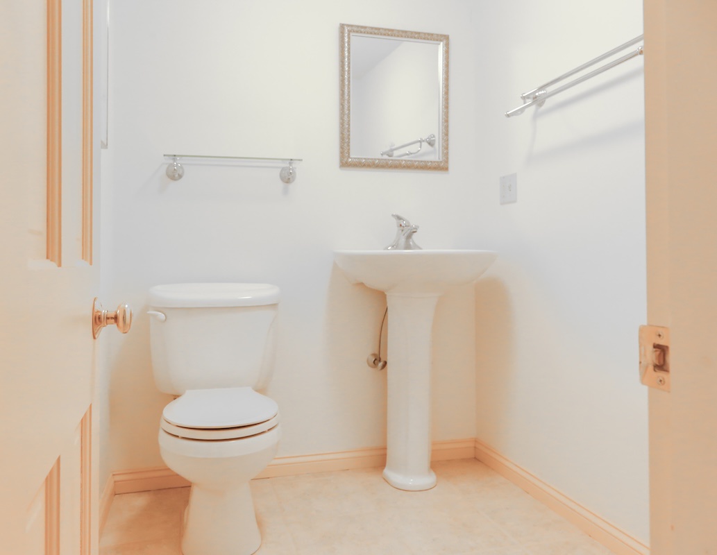 Your private bathroom features a classic pedestal sink and spotless fixtures, offering a clean and comfortable space to freshen up during your stay.