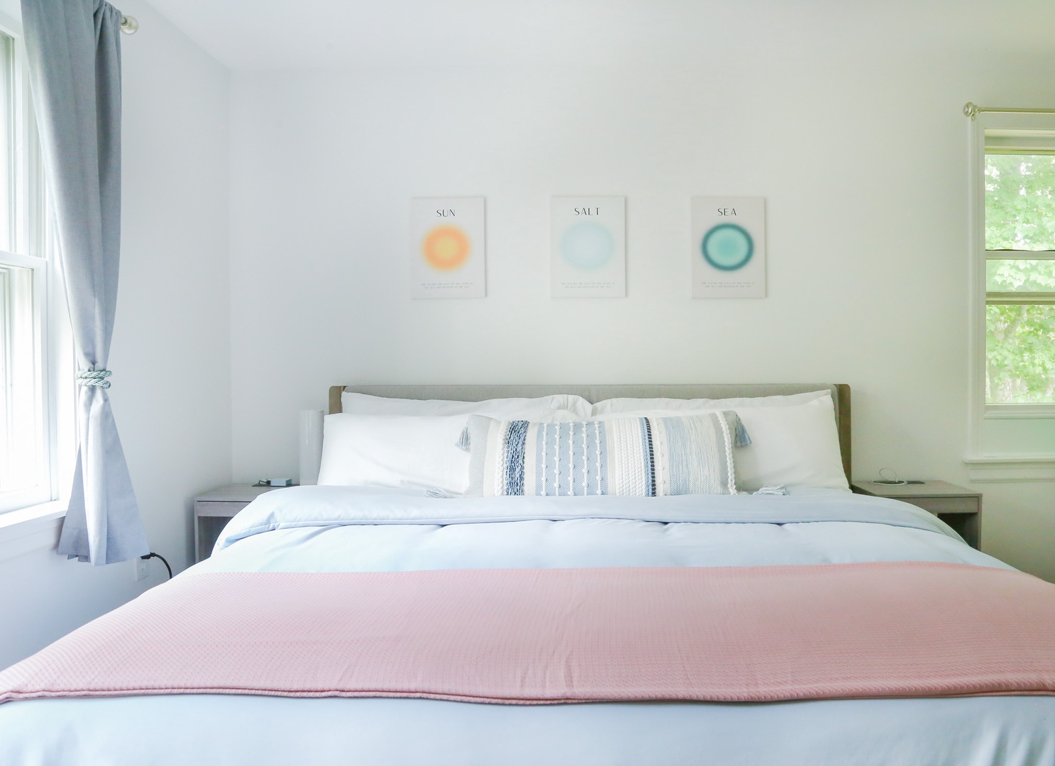 Drift off in this serene bedroom, where soft coastal colors and natural light create your peaceful retreat. The comfortable bed invites you to unwind after a day of exploration.