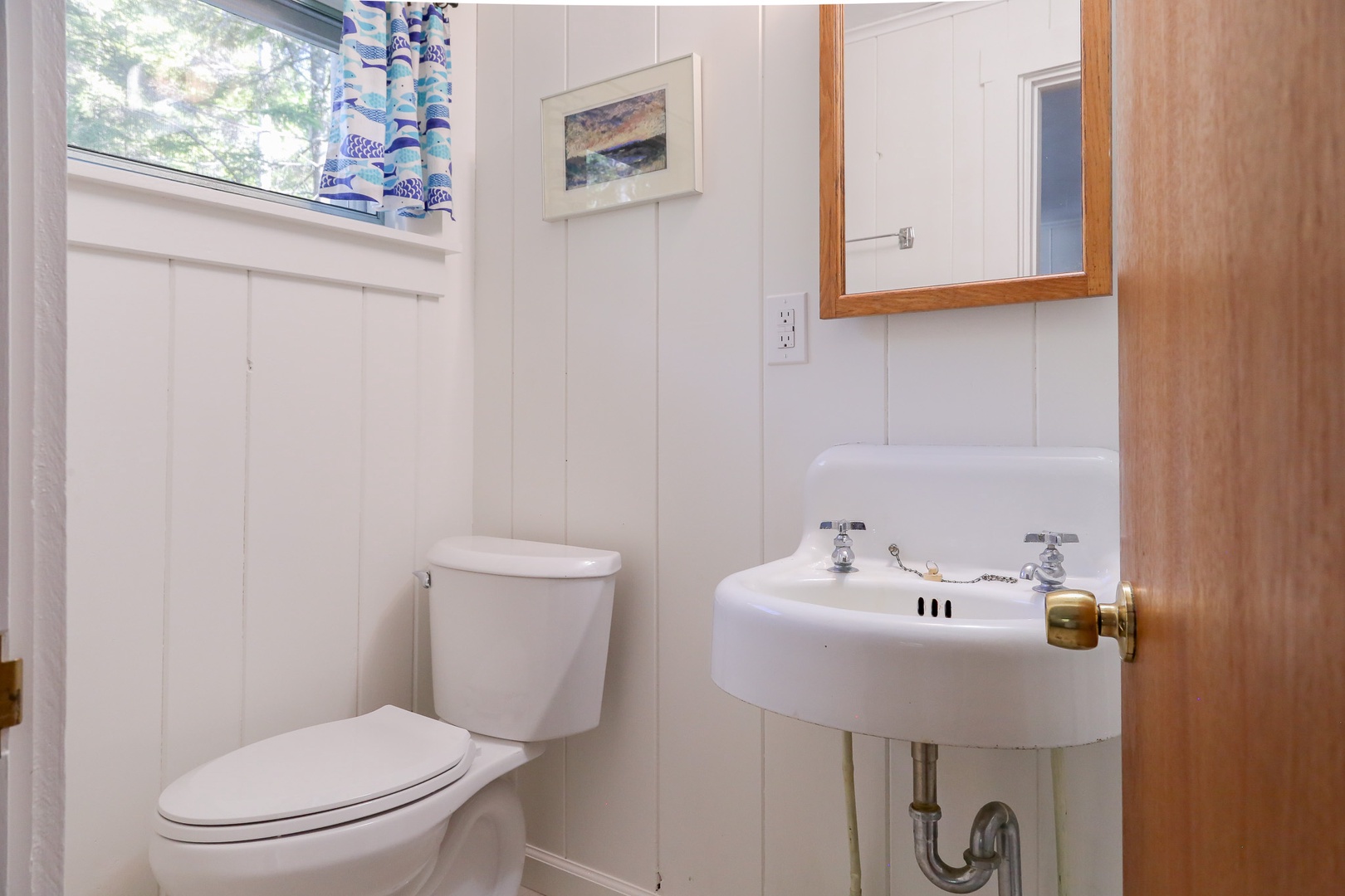Your private bathroom features classic fixtures and natural light from the window, keeping everything bright and welcoming.