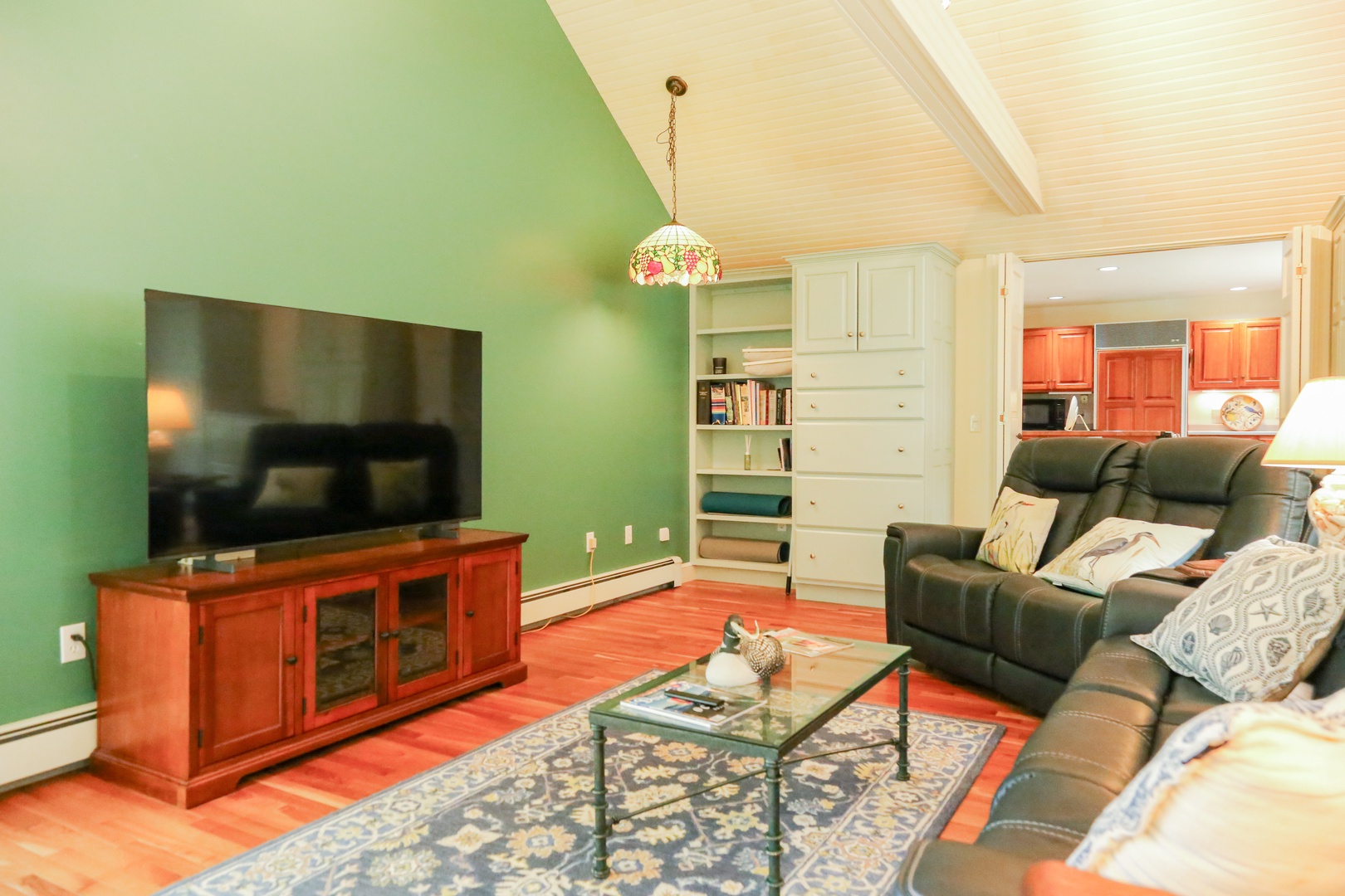 Sink into plush leather seating and unwind in your cozy living space, complete with vaulted ceilings and warm wood tones throughout.