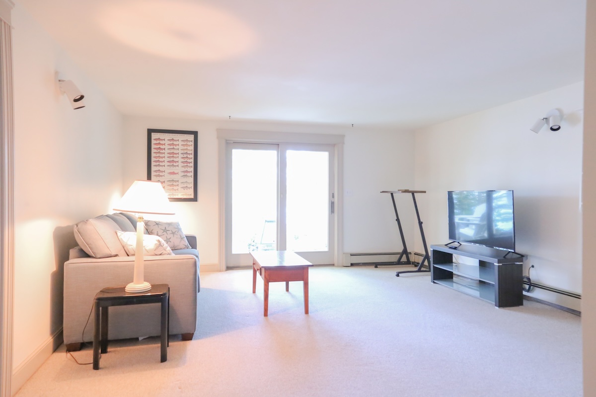 Step into your bright, open living room where natural light pours through sliding doors. Sink into the comfortable sofa, enjoy your favorite shows, and feel instantly at home in this peaceful, airy space.
