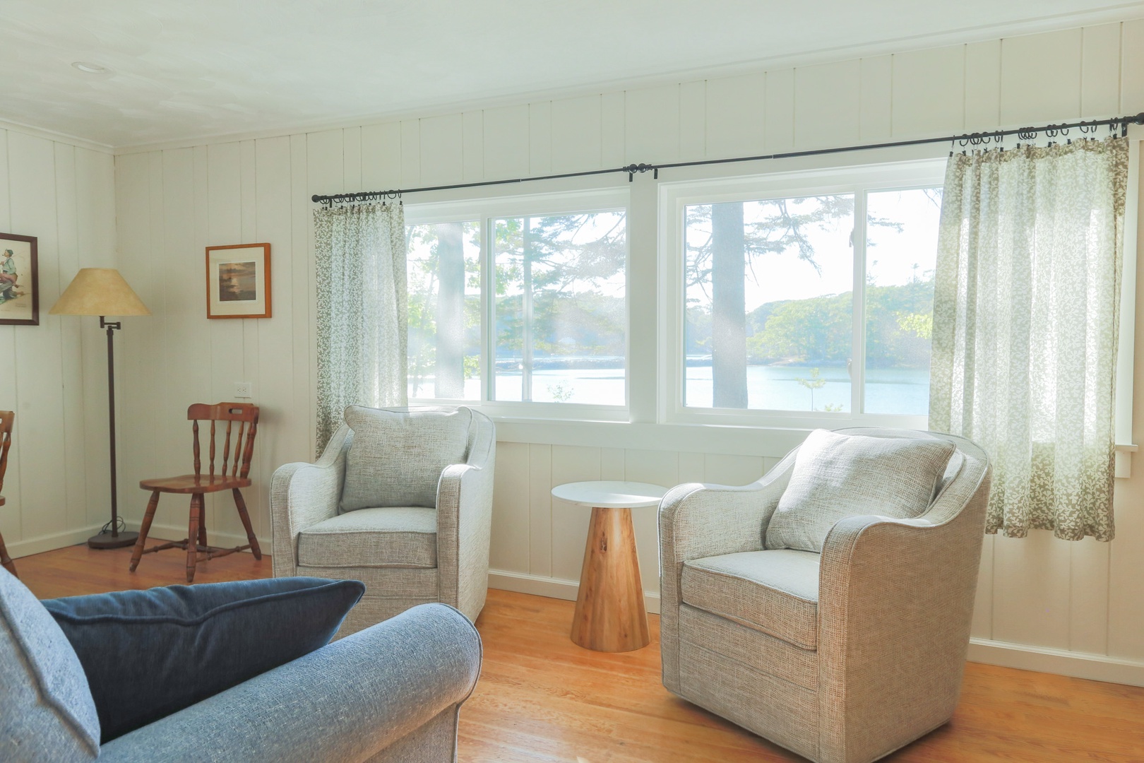 Wake up to peaceful water views framed by soft curtains and sink into plush armchairs perfect for your morning coffee or evening read.