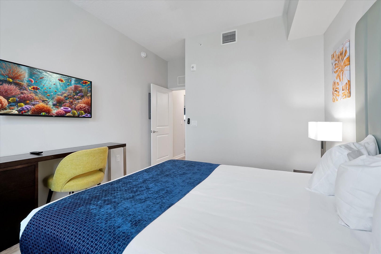 Sink into crisp white linens with ocean-themed artwork creating your perfect retreat sanctuary.