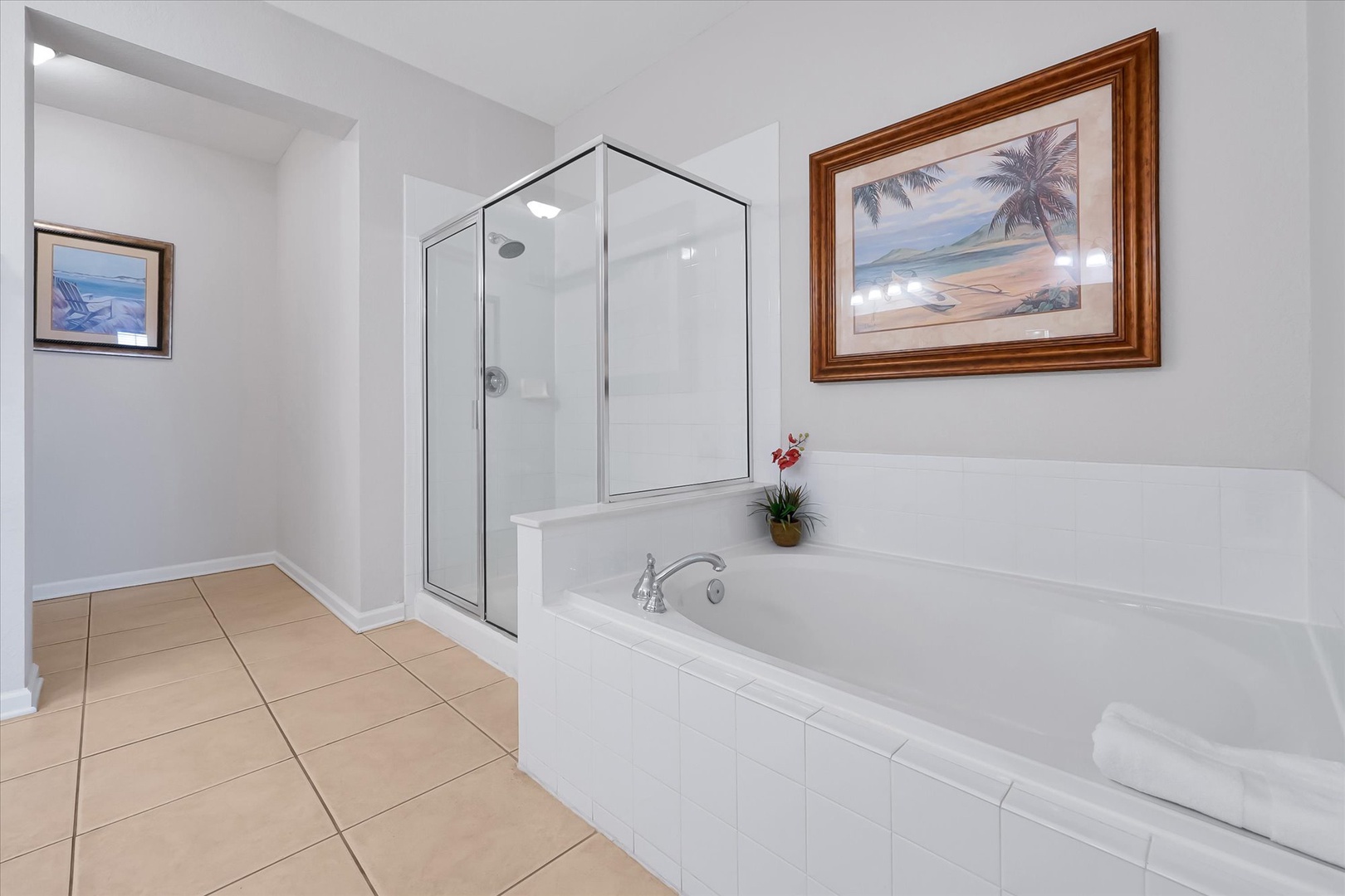 Unwind in your spa-like bathroom with a spacious soaking tub and separate glass shower, perfect for relaxing after beach days.