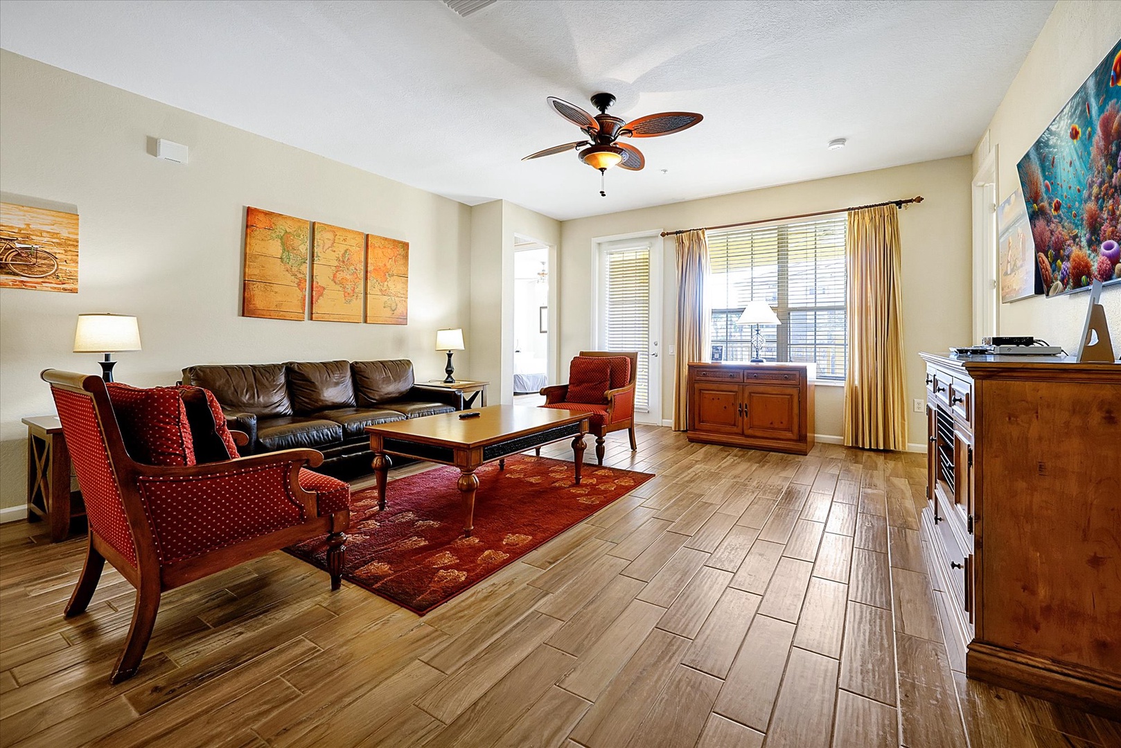 Relax in your spacious living room with rich hardwood floors, leather seating, and warm wood furnishings that create the perfect home-away-from-home atmosphere.